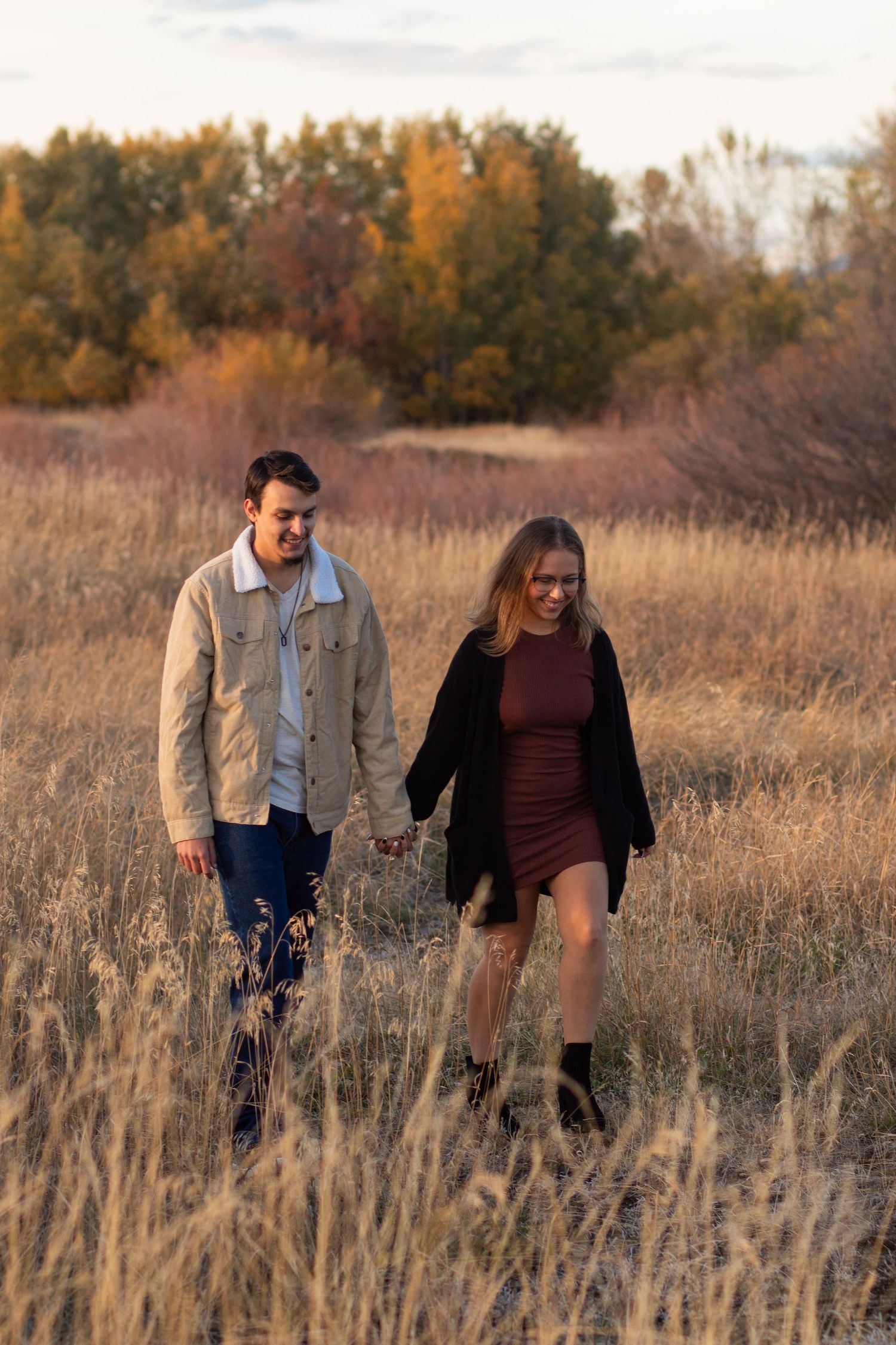 A Bozeman Couple walking together through a field in Bozeman.