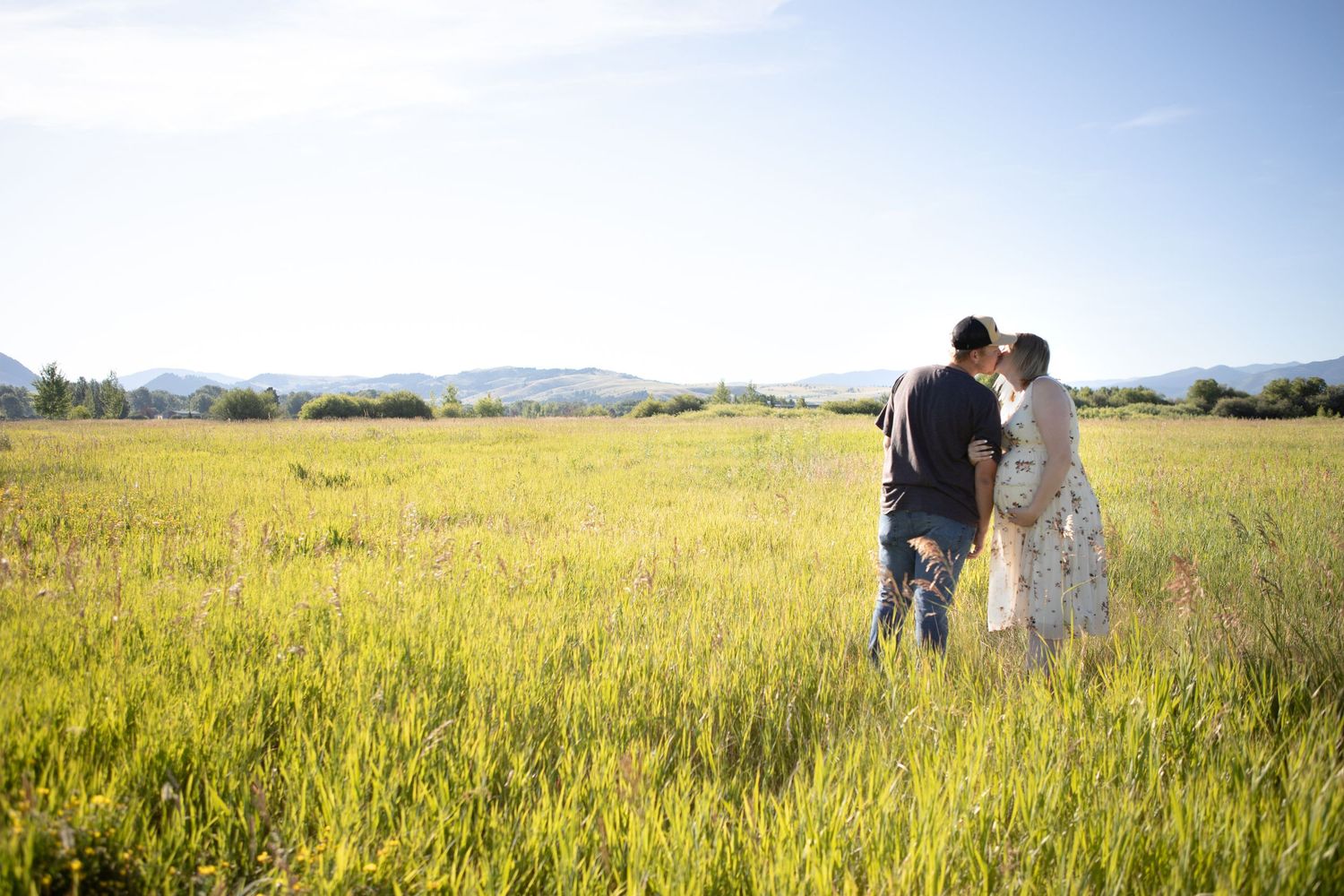 A Bozeman couple kiss in a field in Bozeman, Montana.