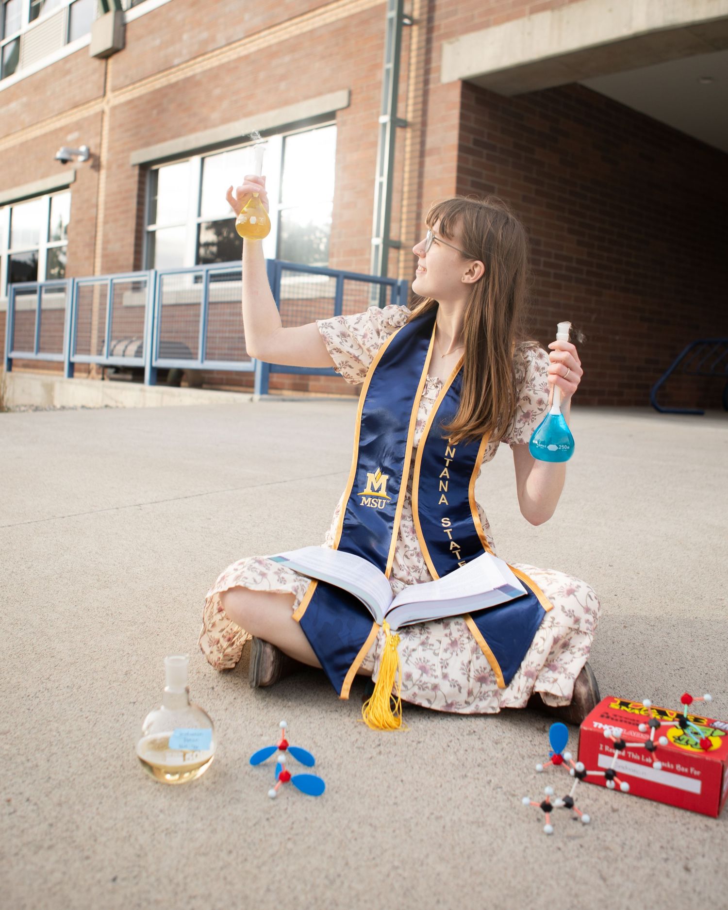 A Montana State University grad sits with her chemistry equipment in Bozeman, Montana.