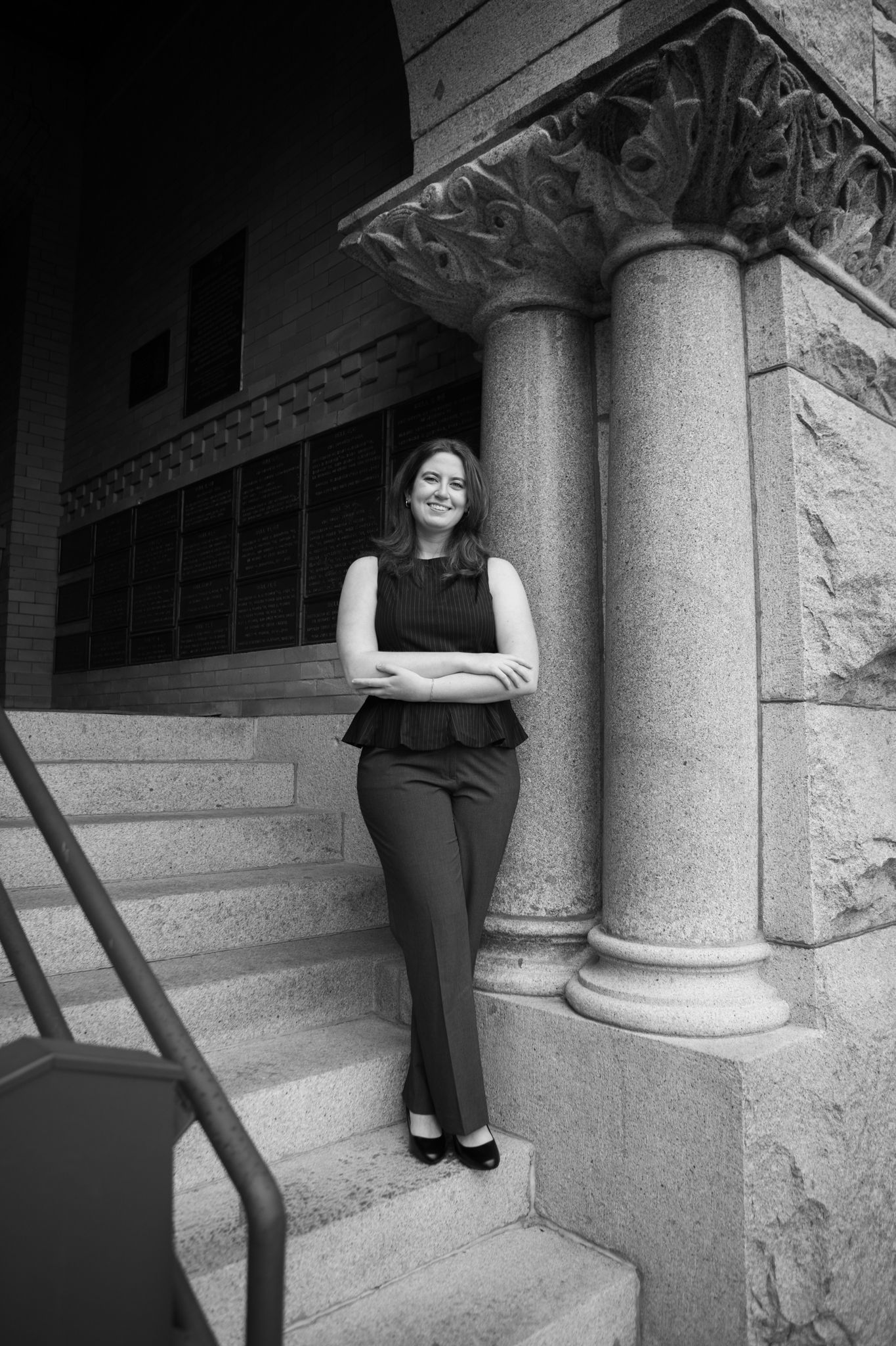 University of Montana Grad stands on the steps of University Hall in Missoula, Montana.