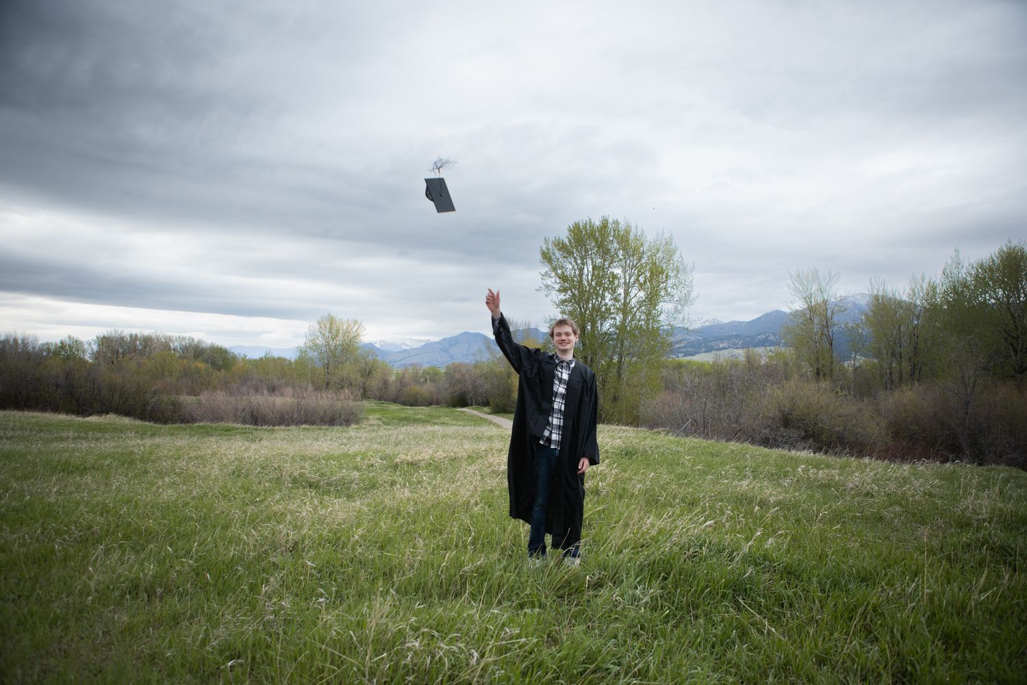 A Belgrade Senior throws his cap in the air in Bozeman, Montana.