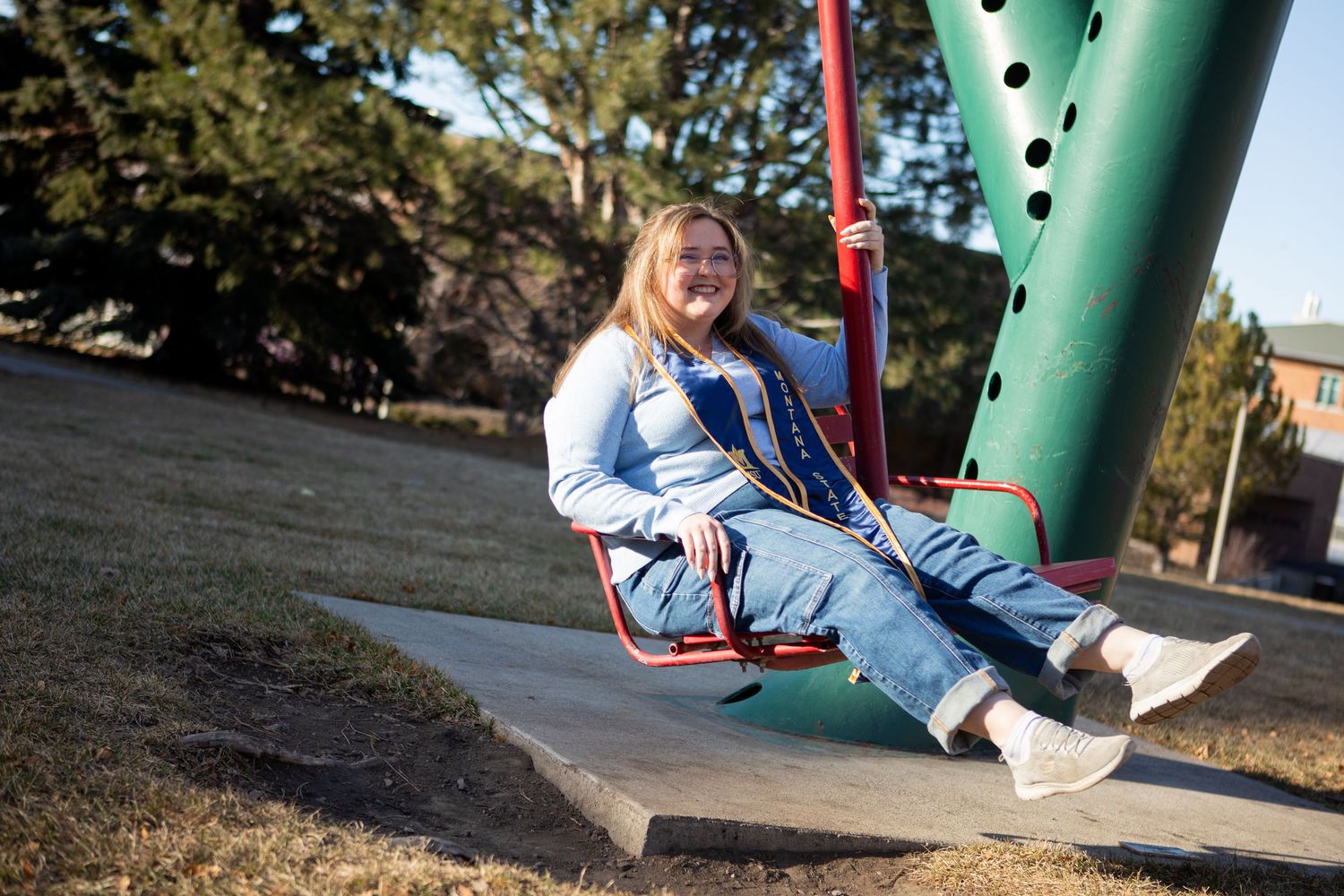 A Montana State grad swings on campus in Bozeman.
