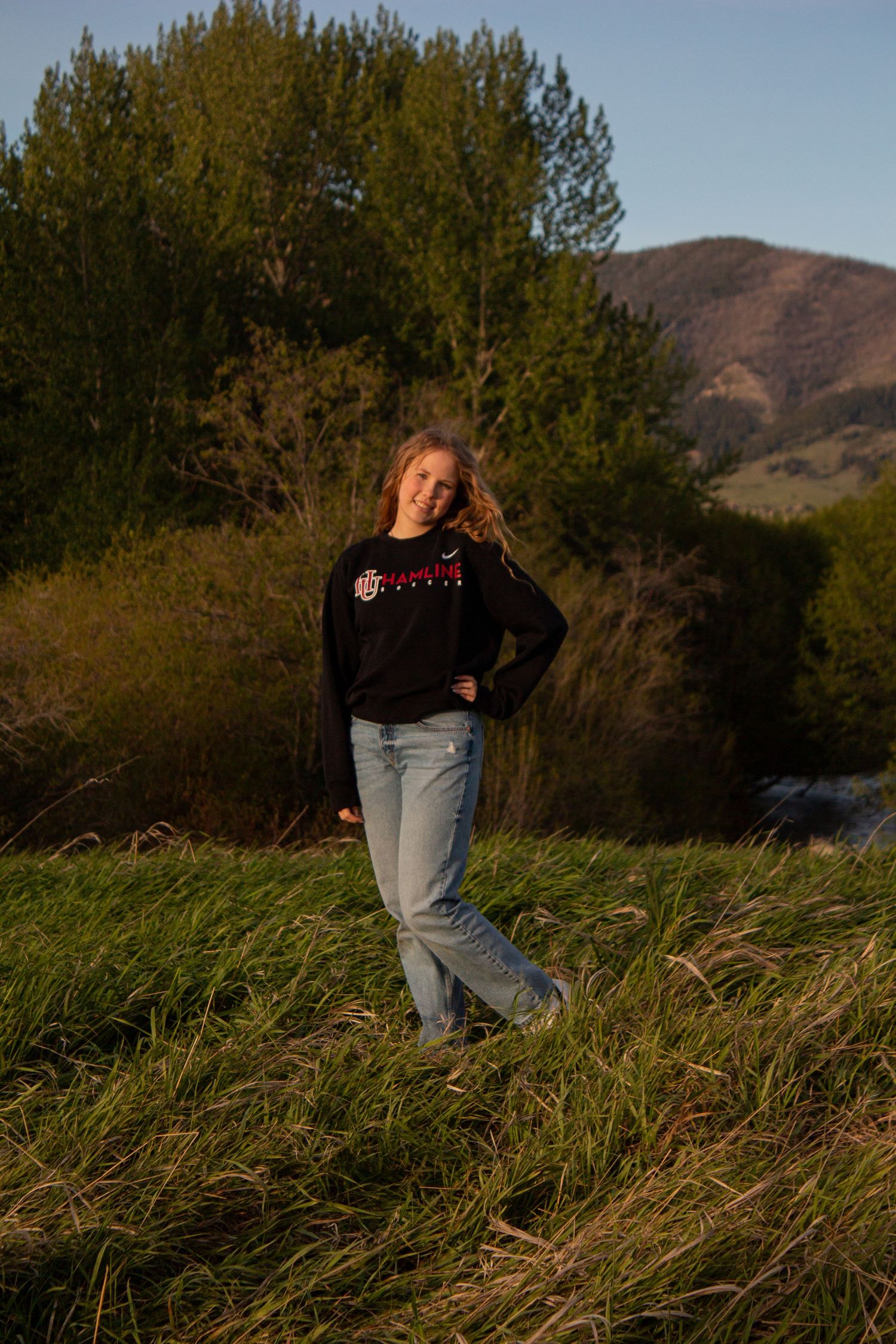 A Bozeman Senior posing in front of the Bridger Mountains.