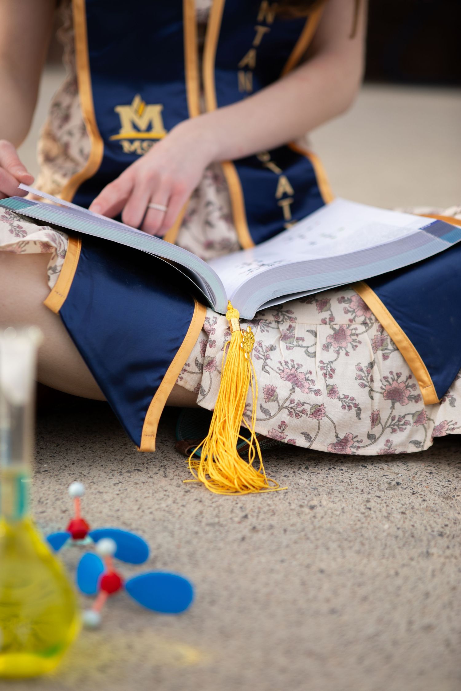 A close up of a Montana State University grad looking through her chemistry textbook in Bozeman, Montana.