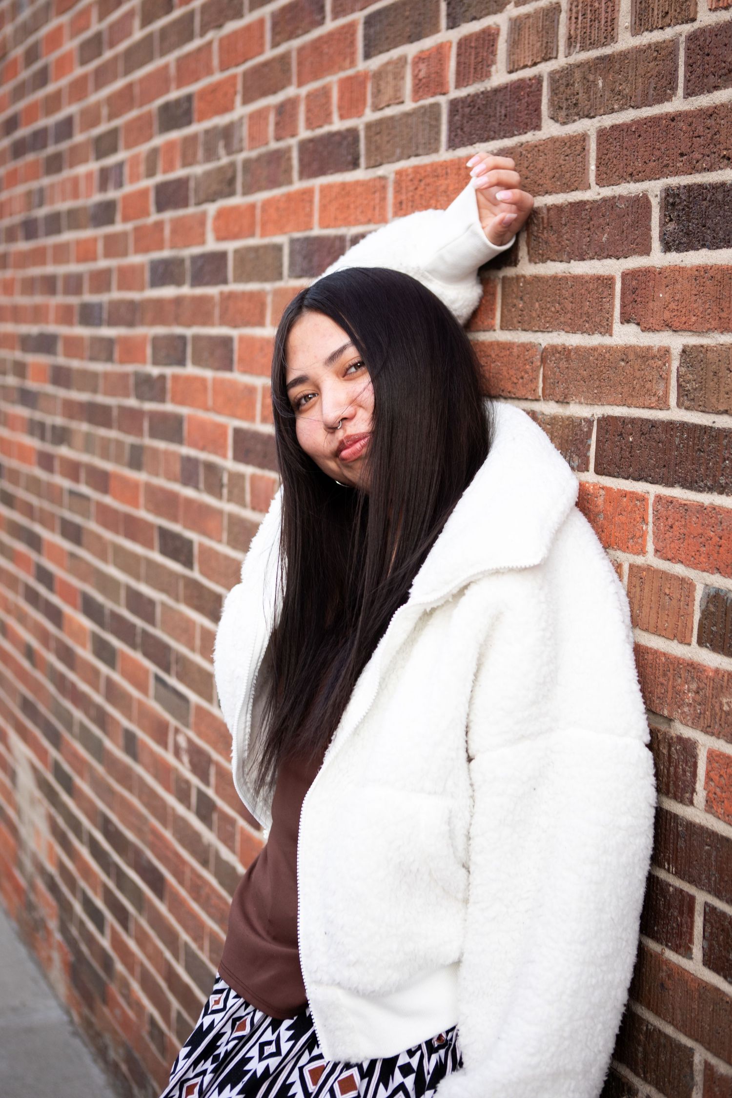 A Bozeman Senior leans against a wall in Downtown Bozeman, Montana