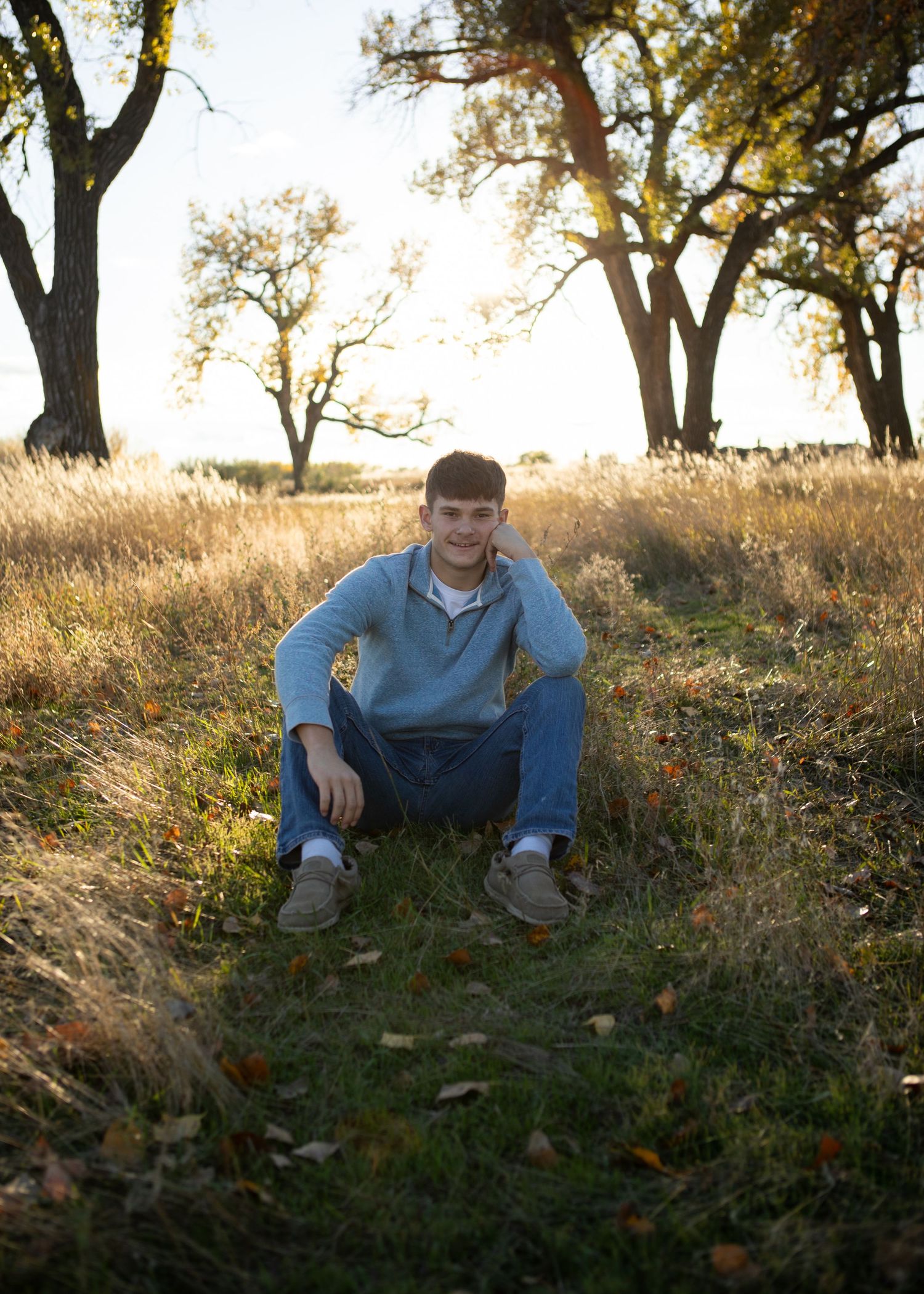 A Bozeman Senior sits in a field in Bozeman, MT.