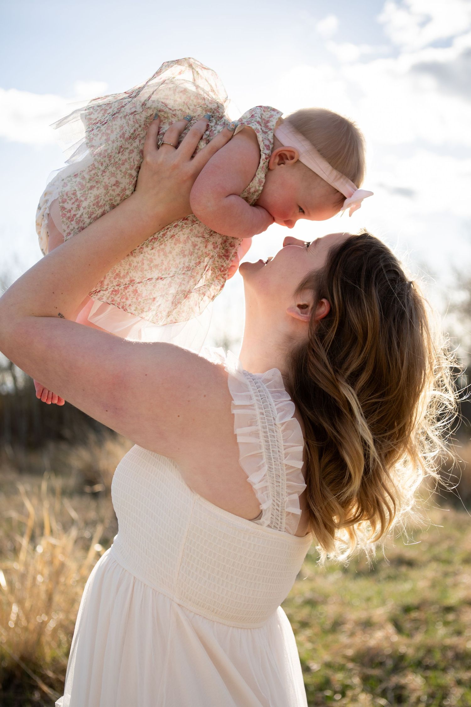 A Bozeman Mom holds her baby in the air in Bozeman, Montana.