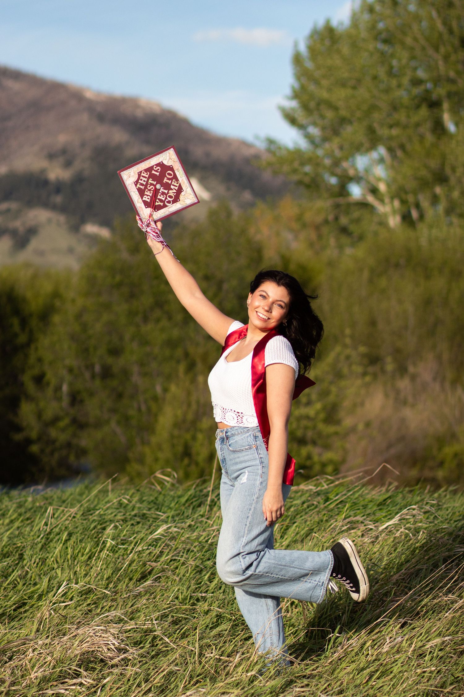 A Bozeman Senior posing with her cap in the Gallatin Valley.