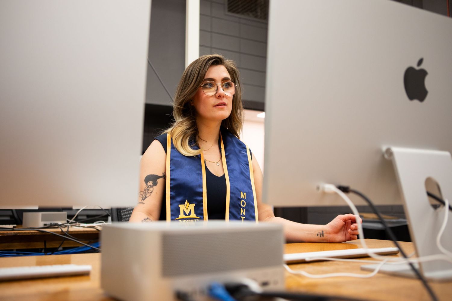 A Montana State University Grad posing in an art lab in Haynes Hall.