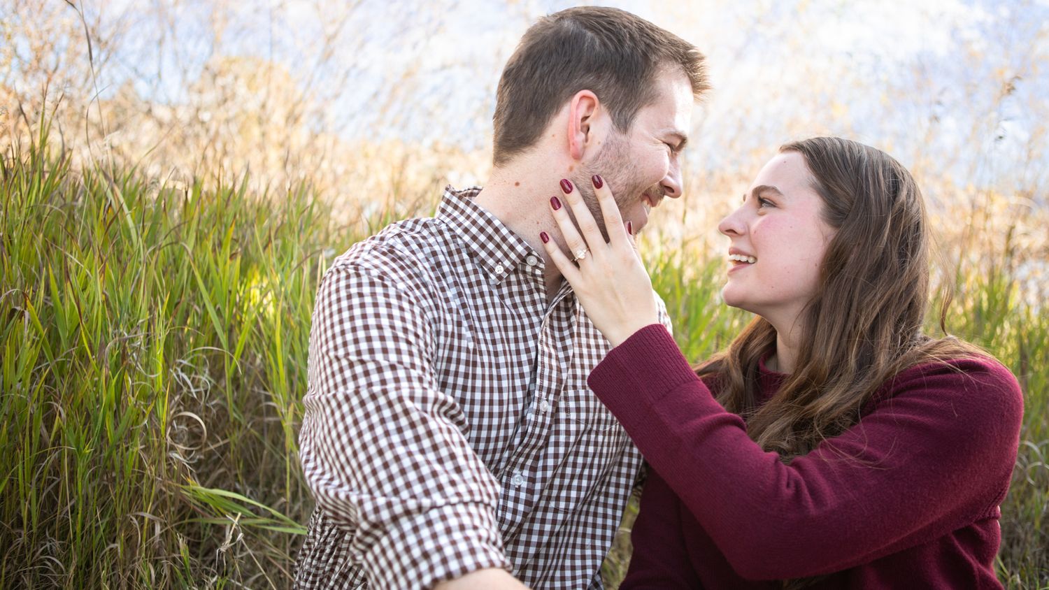 A Montana couple celebrating their engagement in a field in Bozeman, Montana.