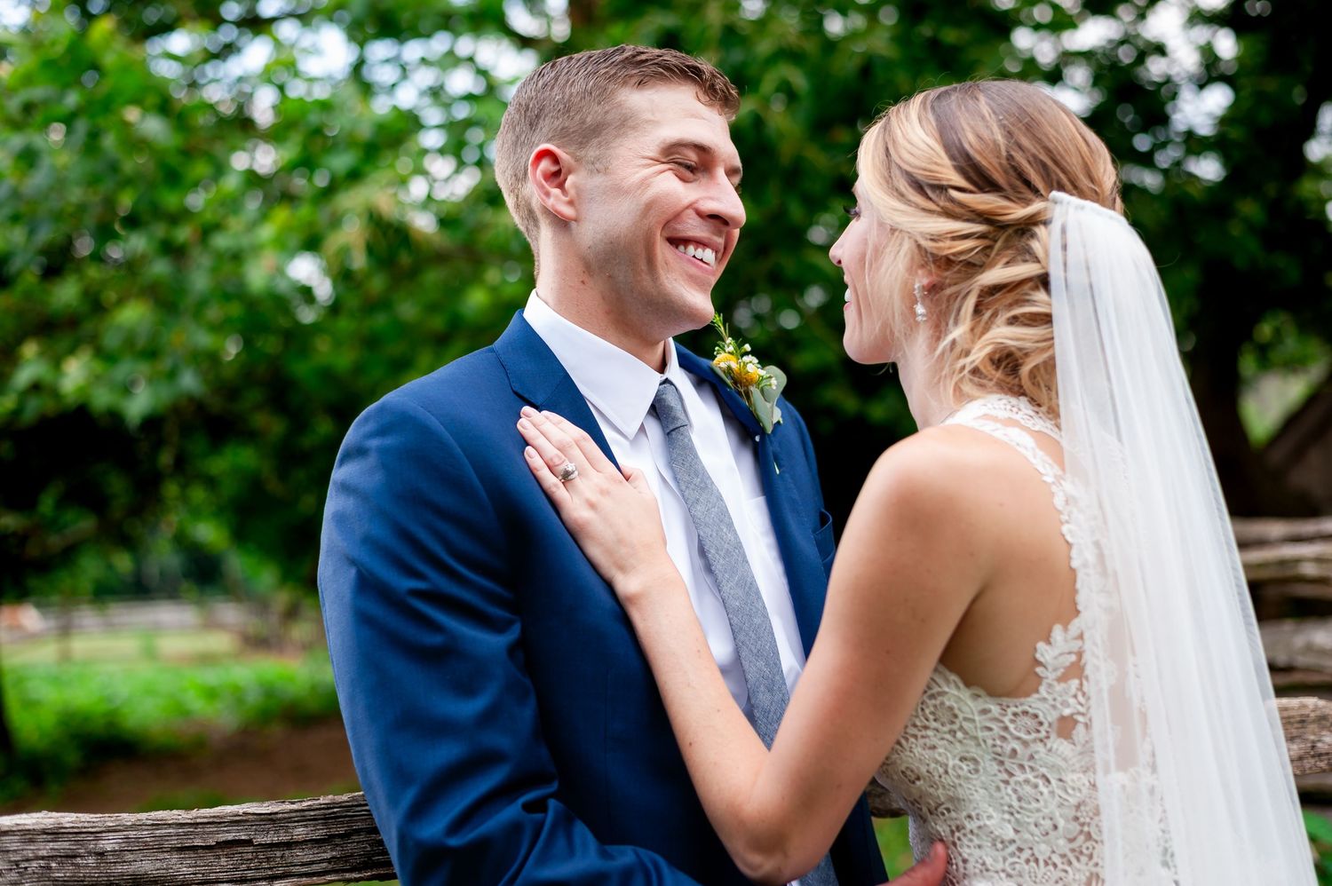 Romantic outdoor wedding portrait with green summer scenery.