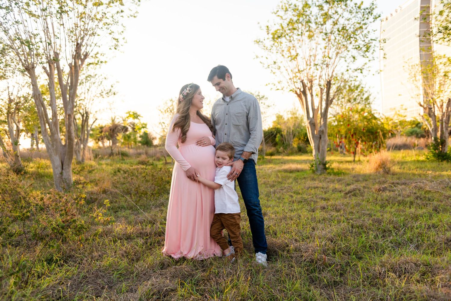 Couple in love share tender moments at sunset in a rustic outdoor field setting.