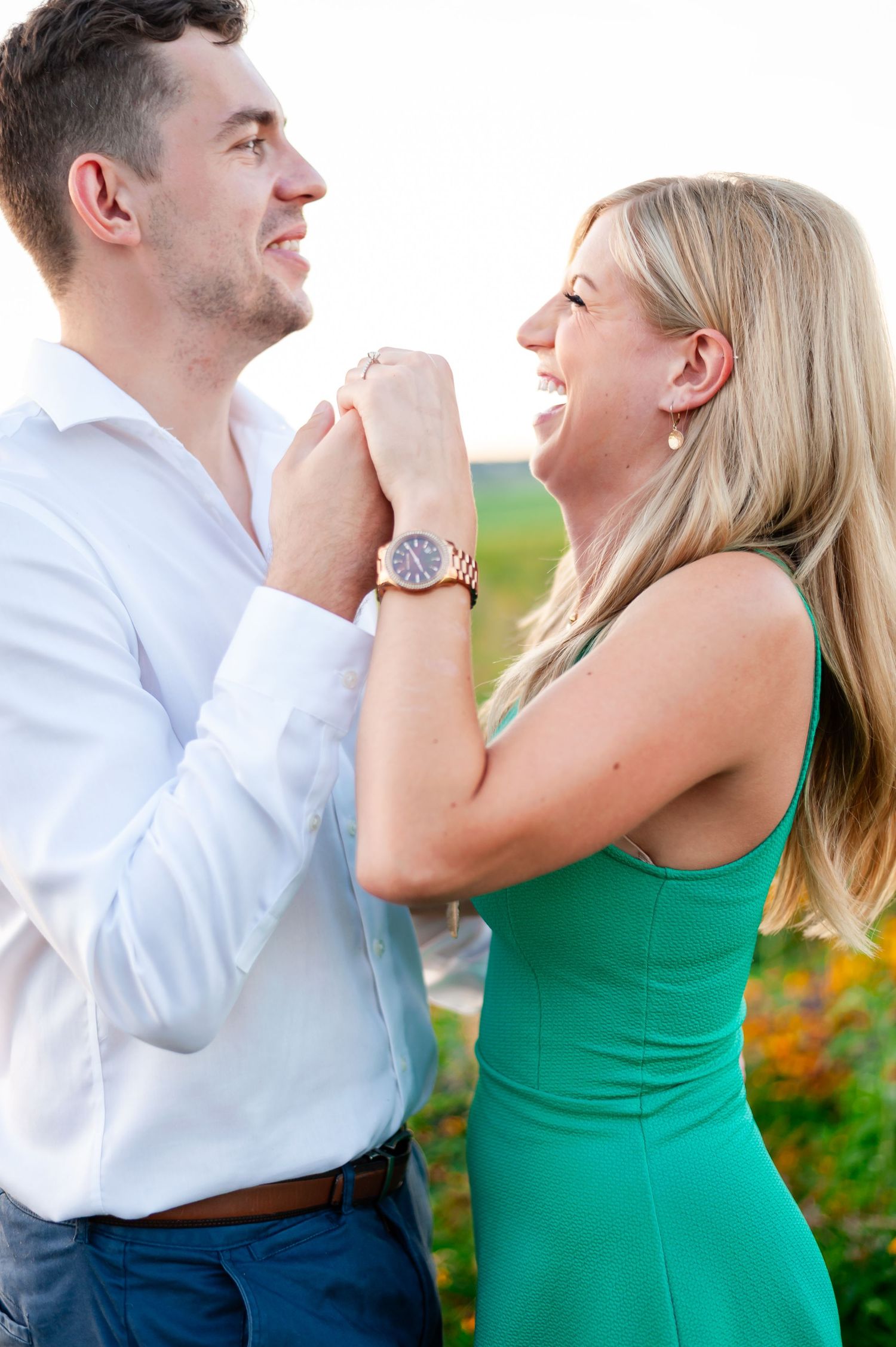 Joyful couple sharing a laugh together in summer garden setting.