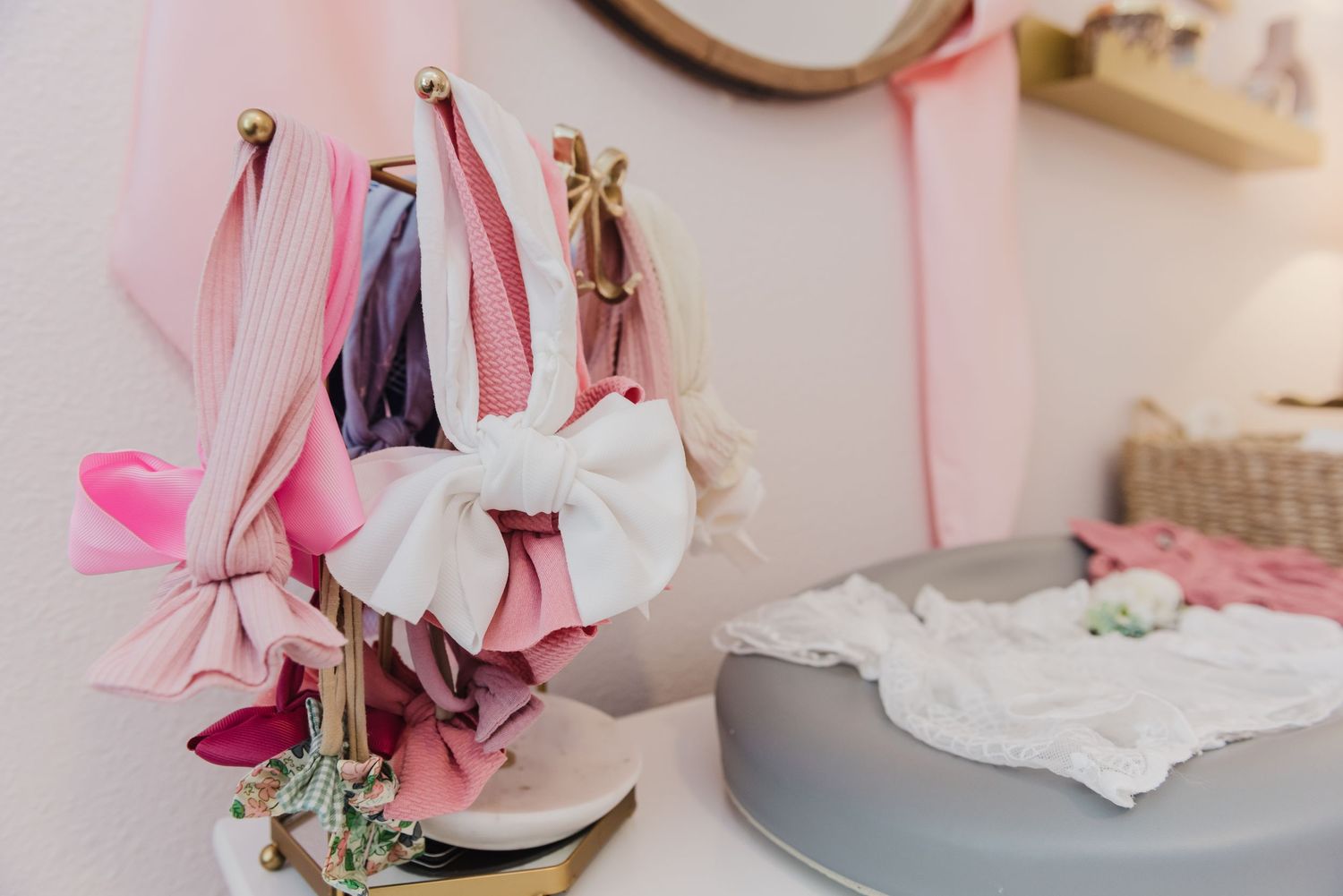 Pink and white nursery decor with delicate ribbons and vintage touches.