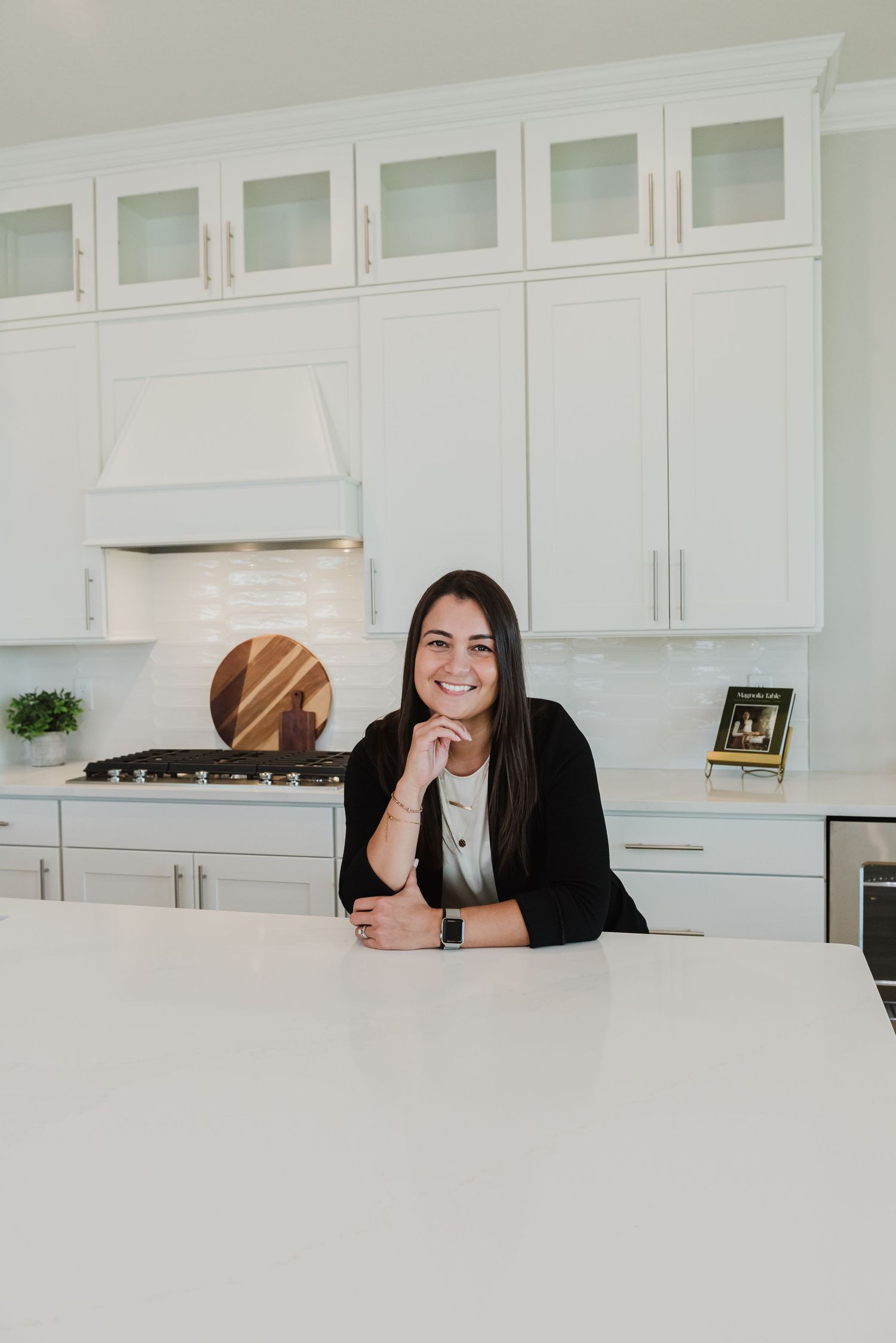 Two people sharing a laugh while sitting at white kitchen counter.