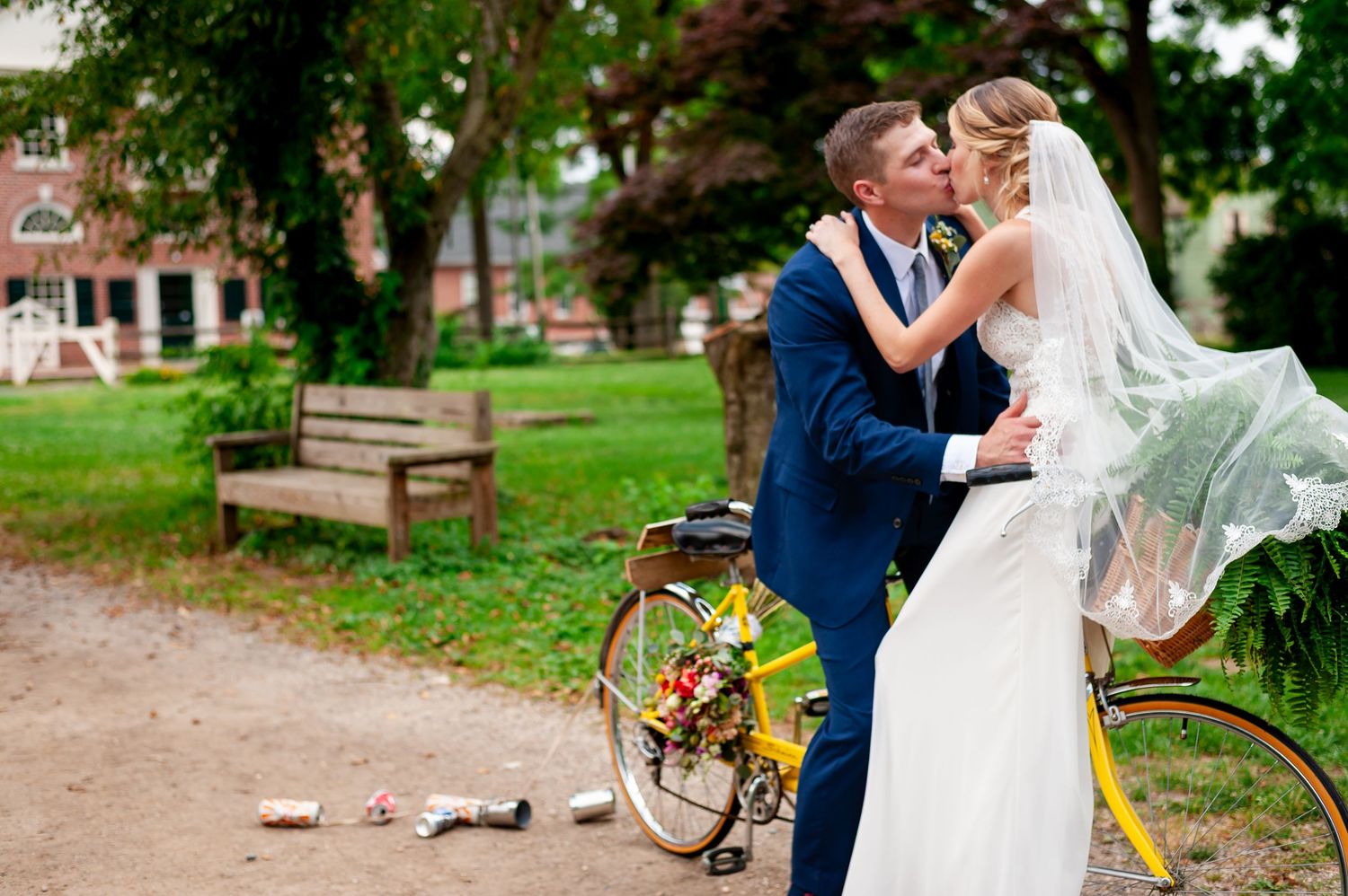 A romantic scene with a vintage bicycle and flowing veil in a park setting.