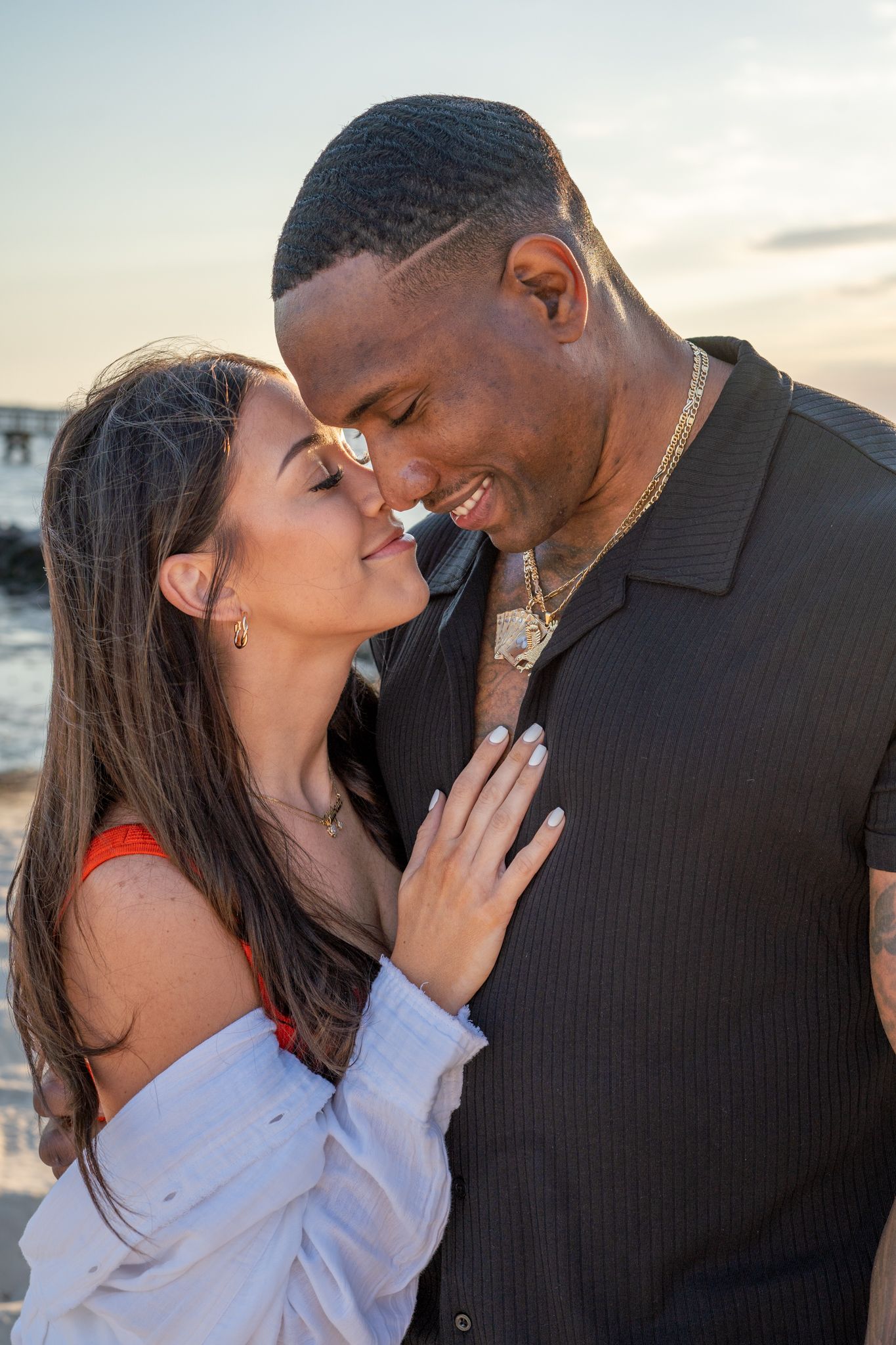 Romantic couple sharing an intimate moment at sunset on the beach.