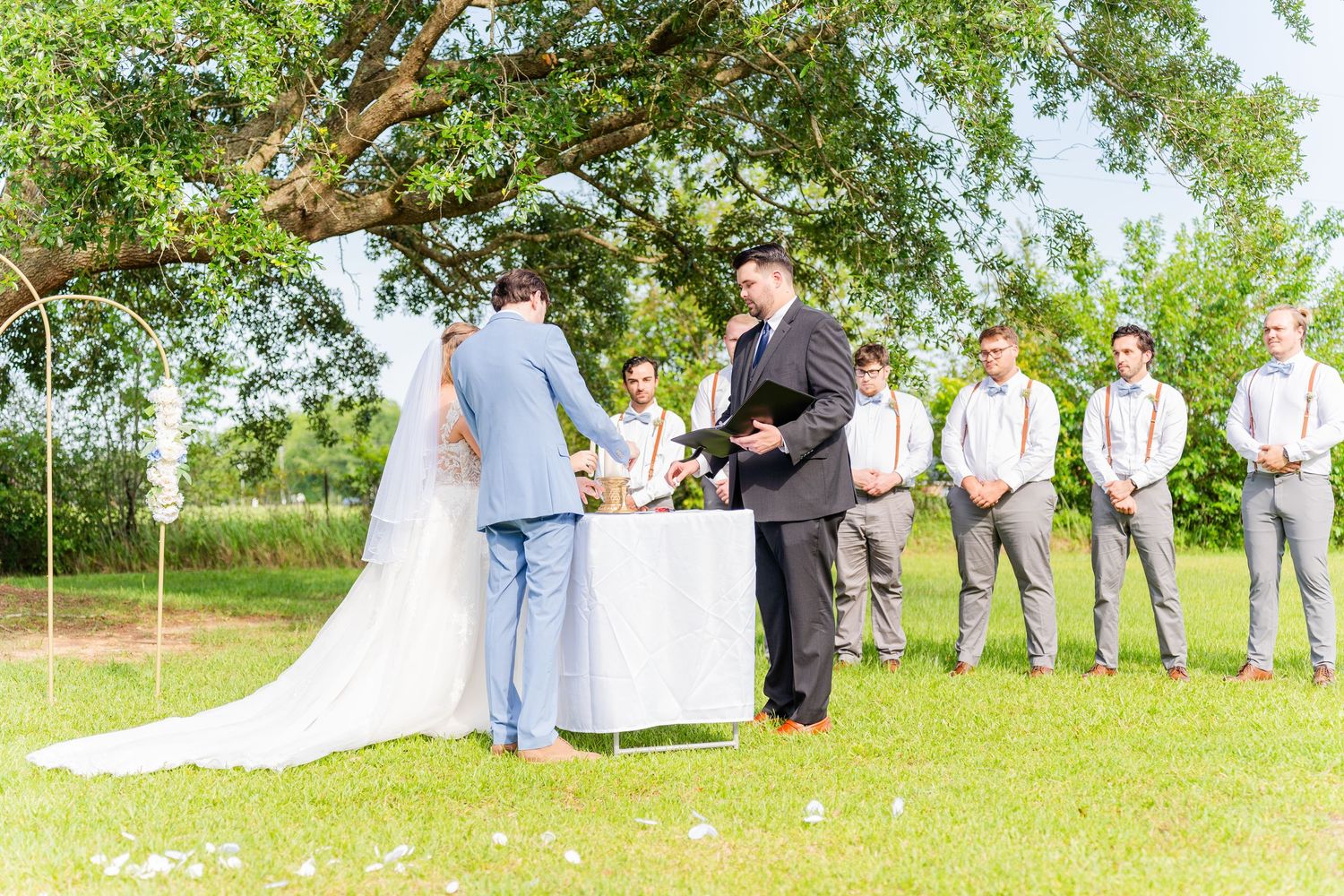 Outdoor wedding party photo sequence on green lawn.