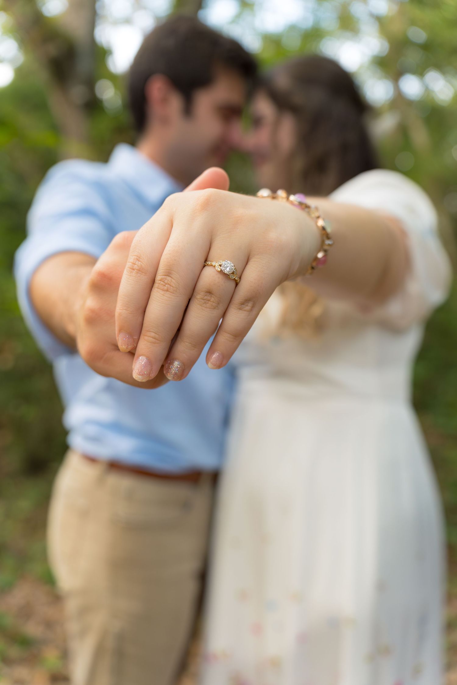 A series showing an engagement ring sparkle with a blurred natural background.