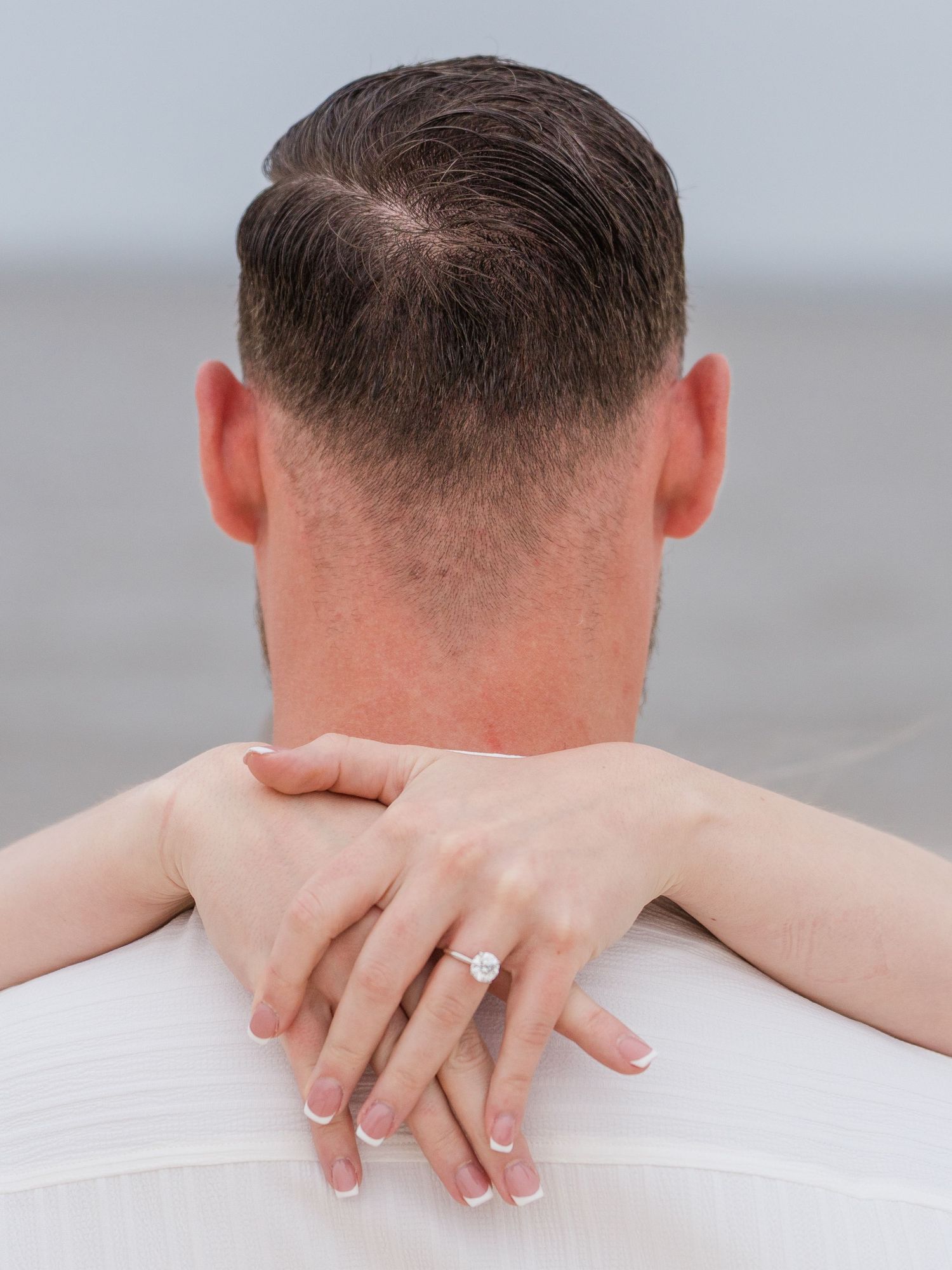 Close up detail shots of hands and back during intimate couple's photoshoot.