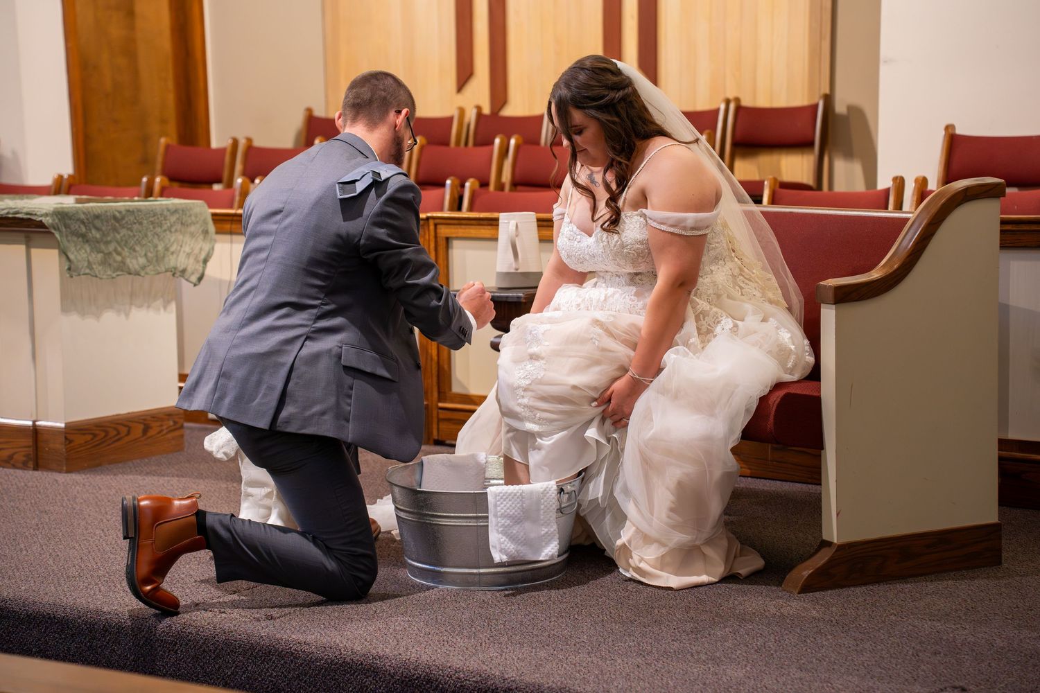 A sequence of images showing someone kneeling and proposing in a formal setting with red chairs and white decor.