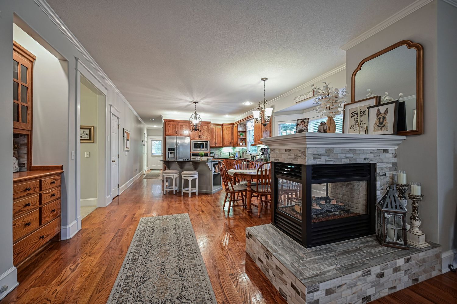 kitchen with hardwood floors, a fireplace, and custom cabinets
