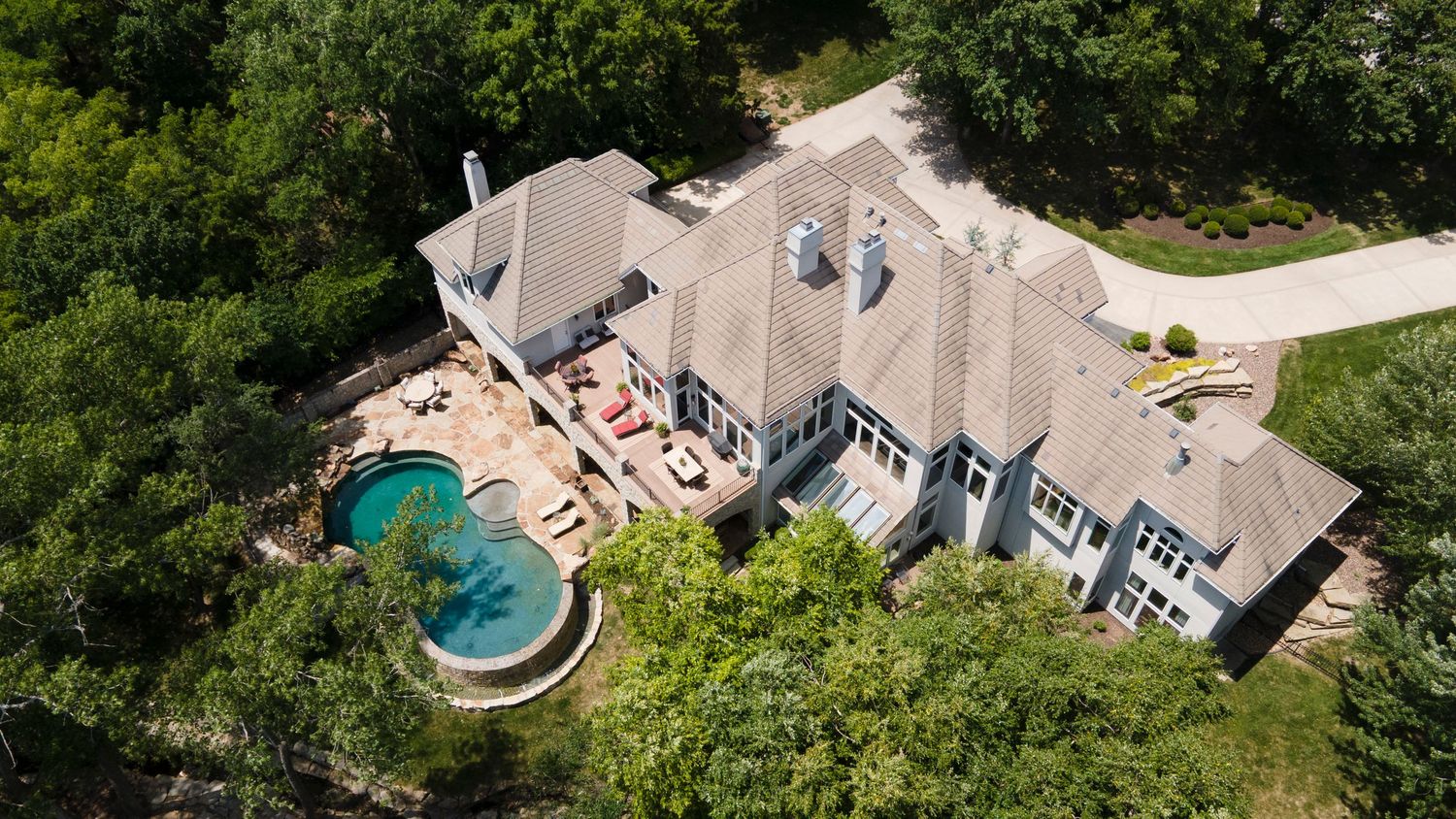 Aerial photo of a large home with a pool in the back yard