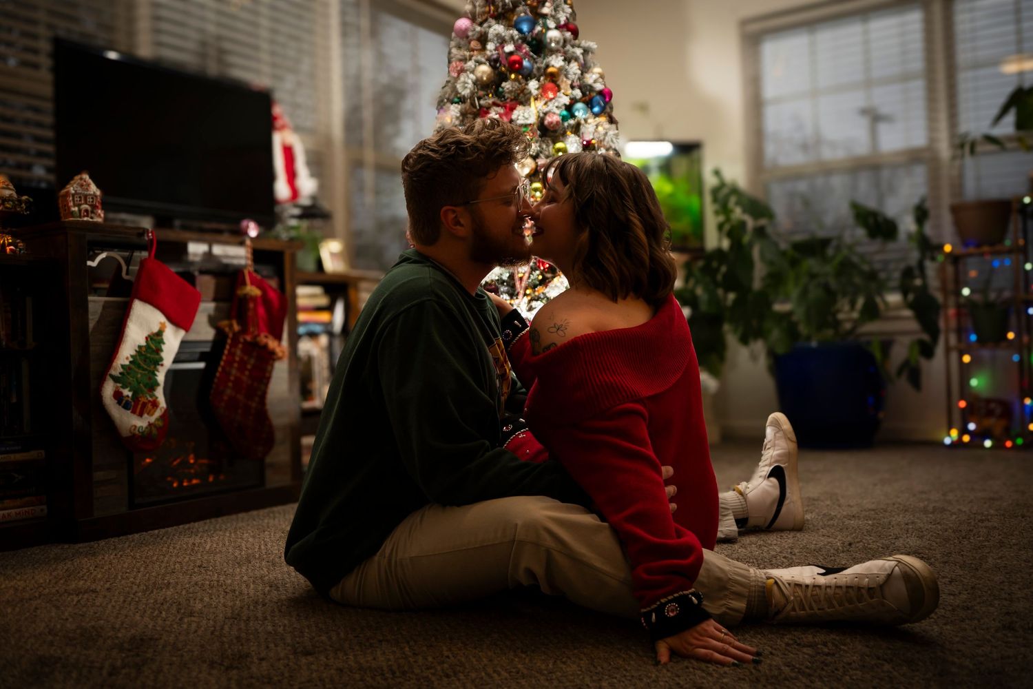 Portrait of cute couple face to face in front of their Christmas tree