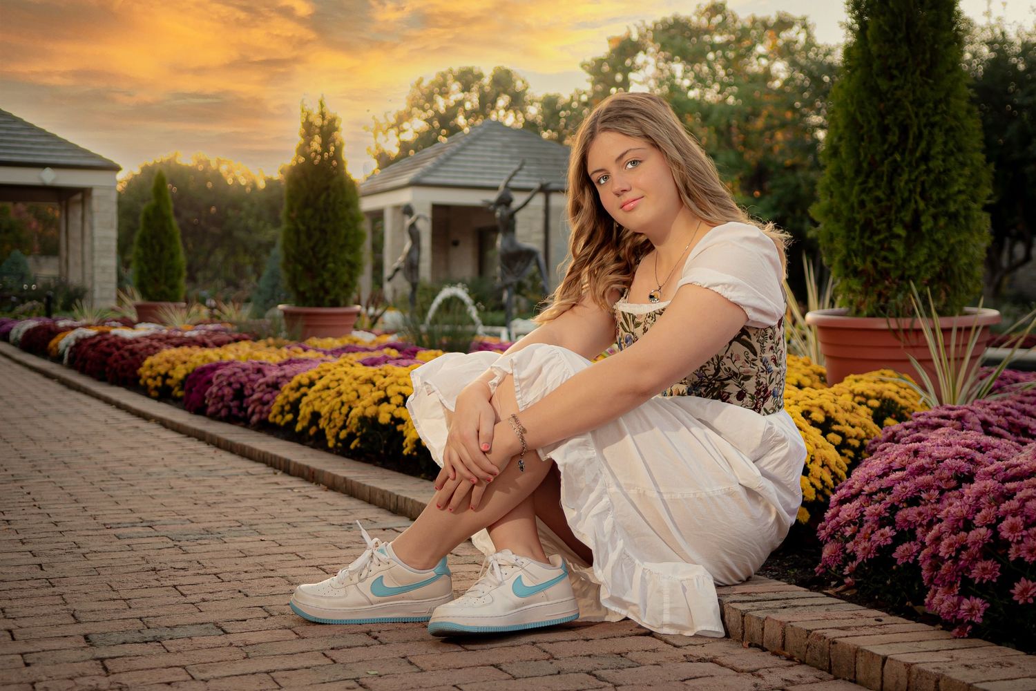 Senior portraits/ Kauffman Memorial Garden/ girl in dress sitting by beautiful flowers