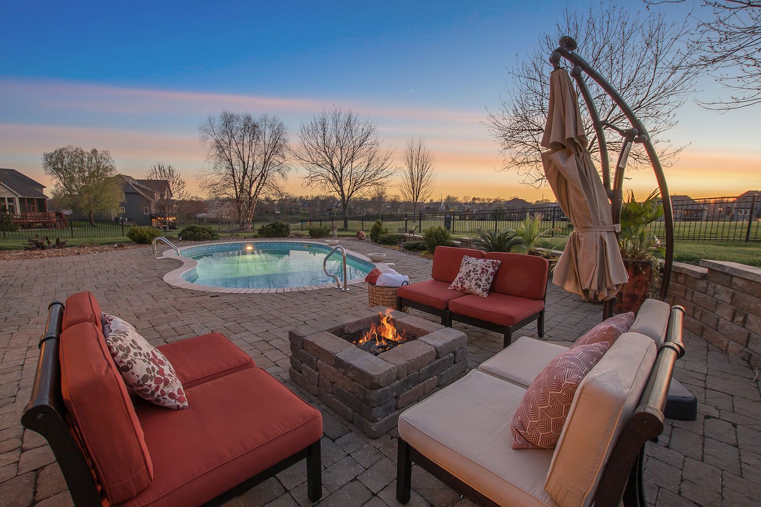 back yard patio with firepit and furniture with a pool