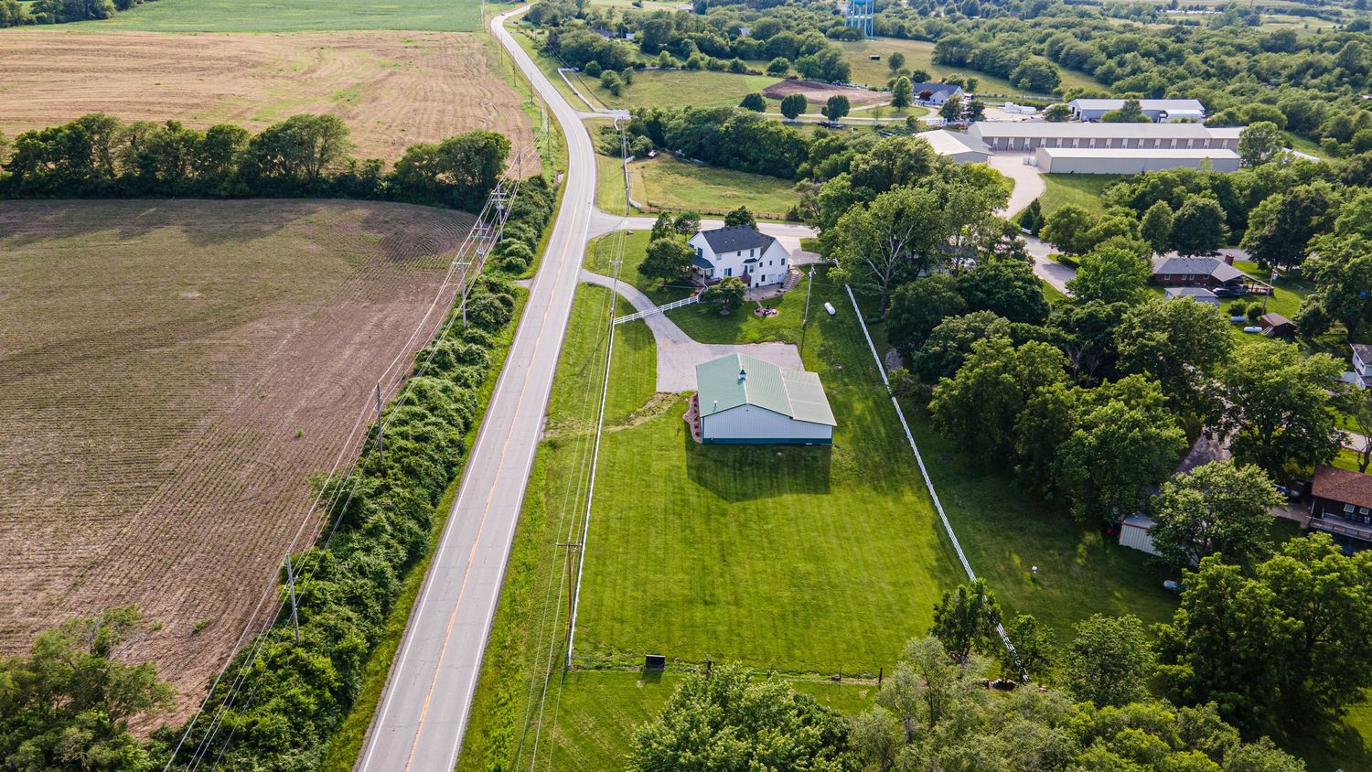 aerial photo of a home and barn on acreage