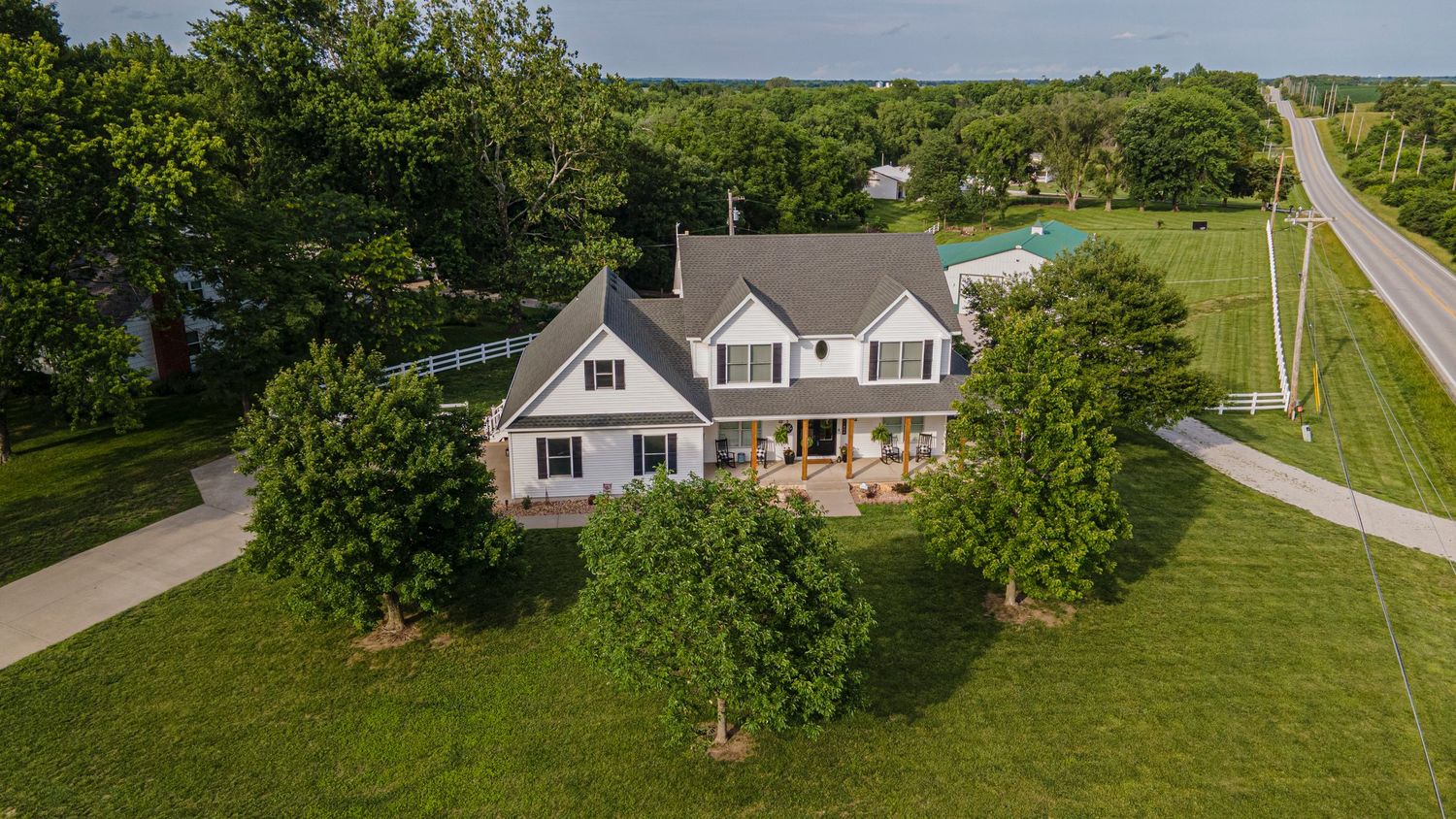 aerial photo of a white house with acreage
