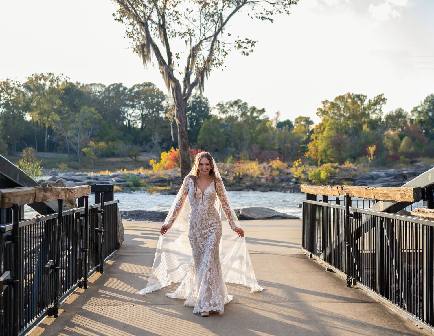 Scenic waterfront wedding photography with iron railings and natural landscape.
