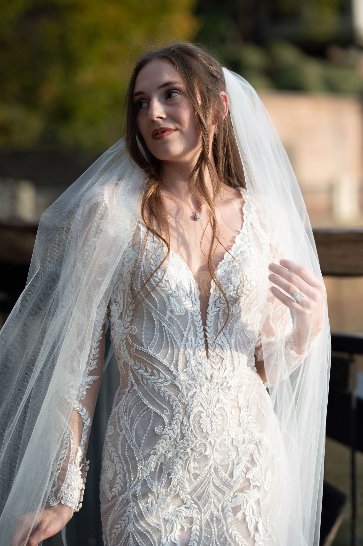 Ethereal bridal portraits featuring intricate lace details and flowing veil in natural lighting.