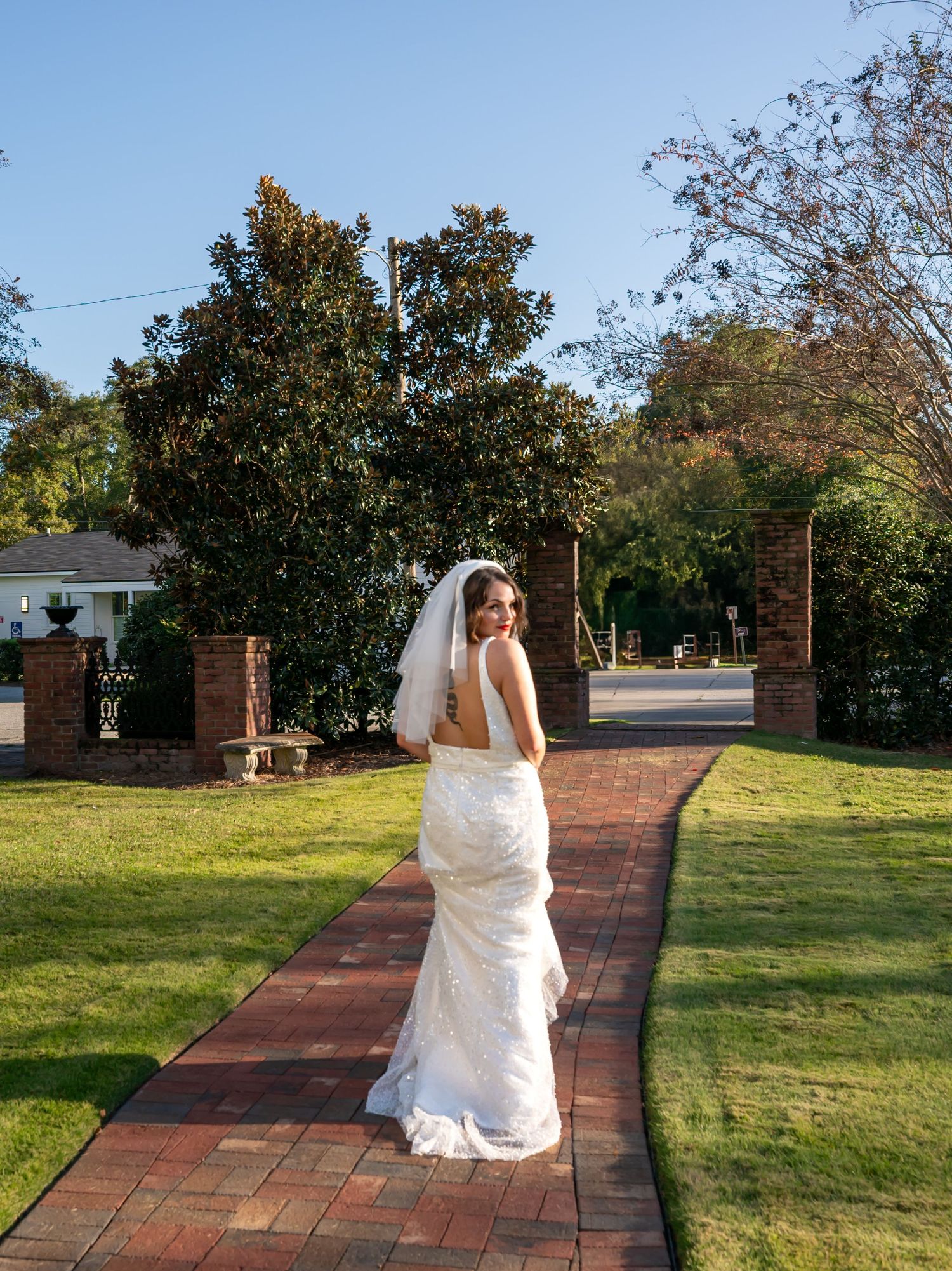 A series of photos showing a person in a white dress crossing a brick pathway through a green lawn on a sunny day.