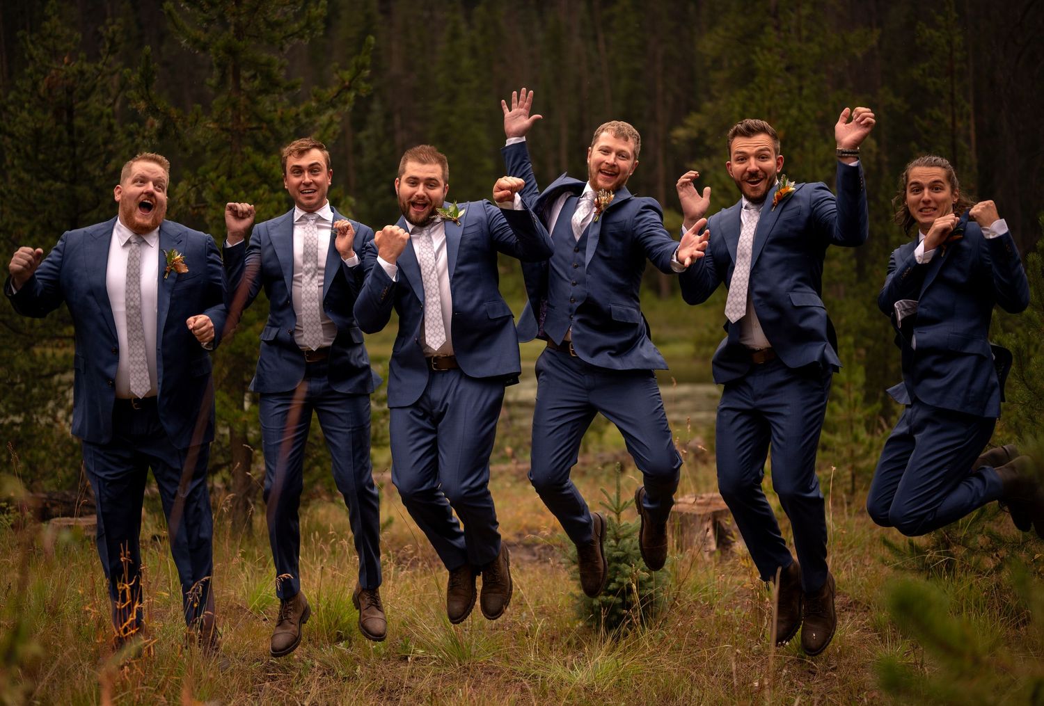 Groom and his groomsmen having fun taking grooms photographs jumping all at once together in Georgia