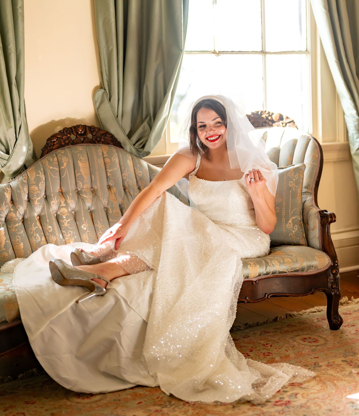 A collage showing five elegant poses of someone in a white wedding dress lounging gracefully on an antique blue sofa.
