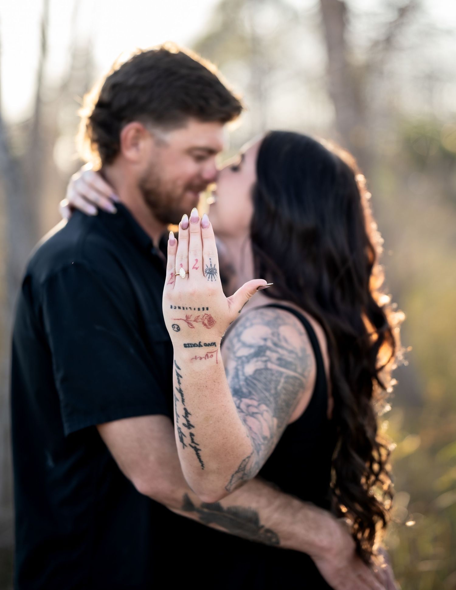 Intimate engagement photos showing couple's affection in natural setting.