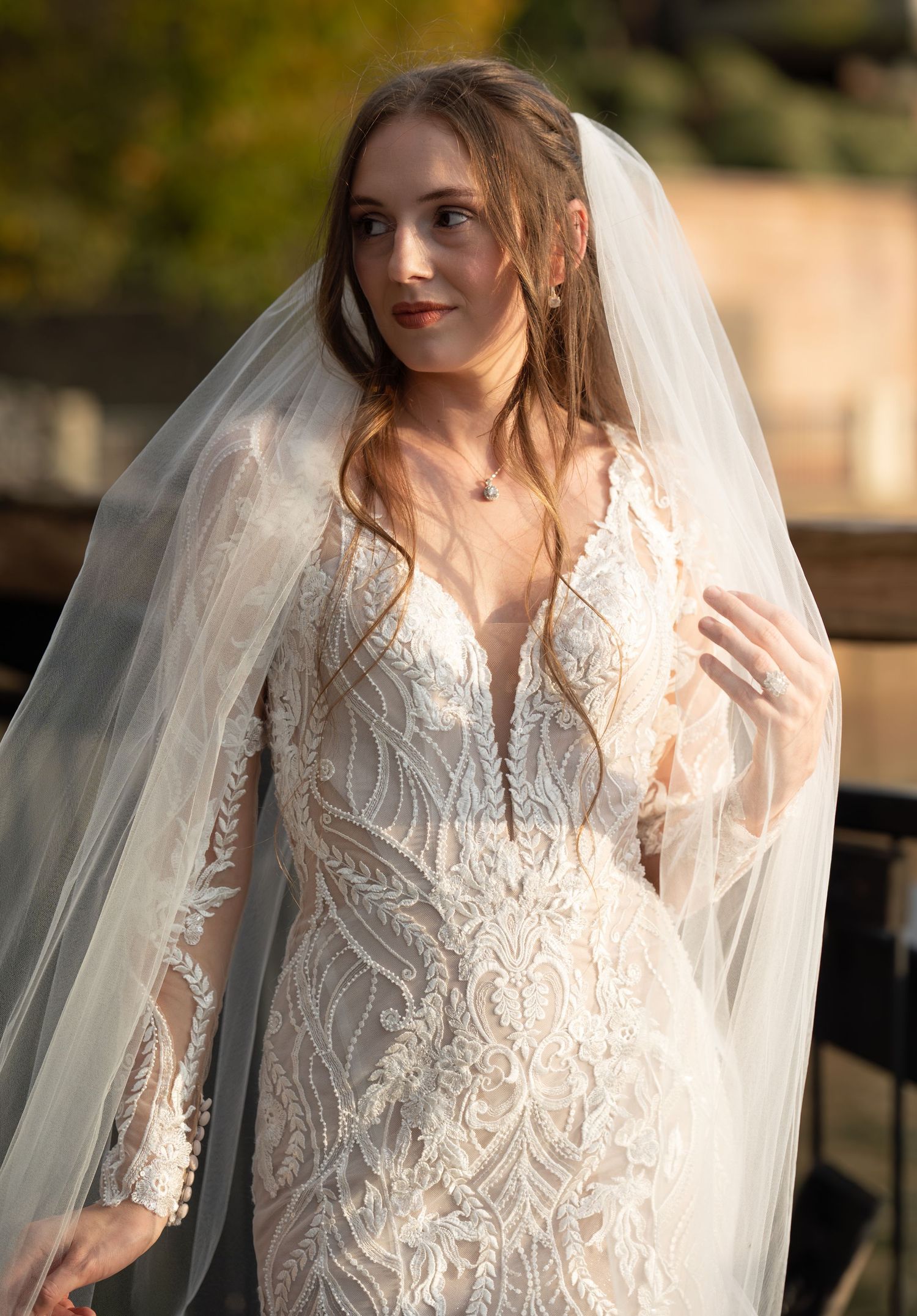 A close-up bridal portrait highlighting intricate lace patterns and soft lighting.