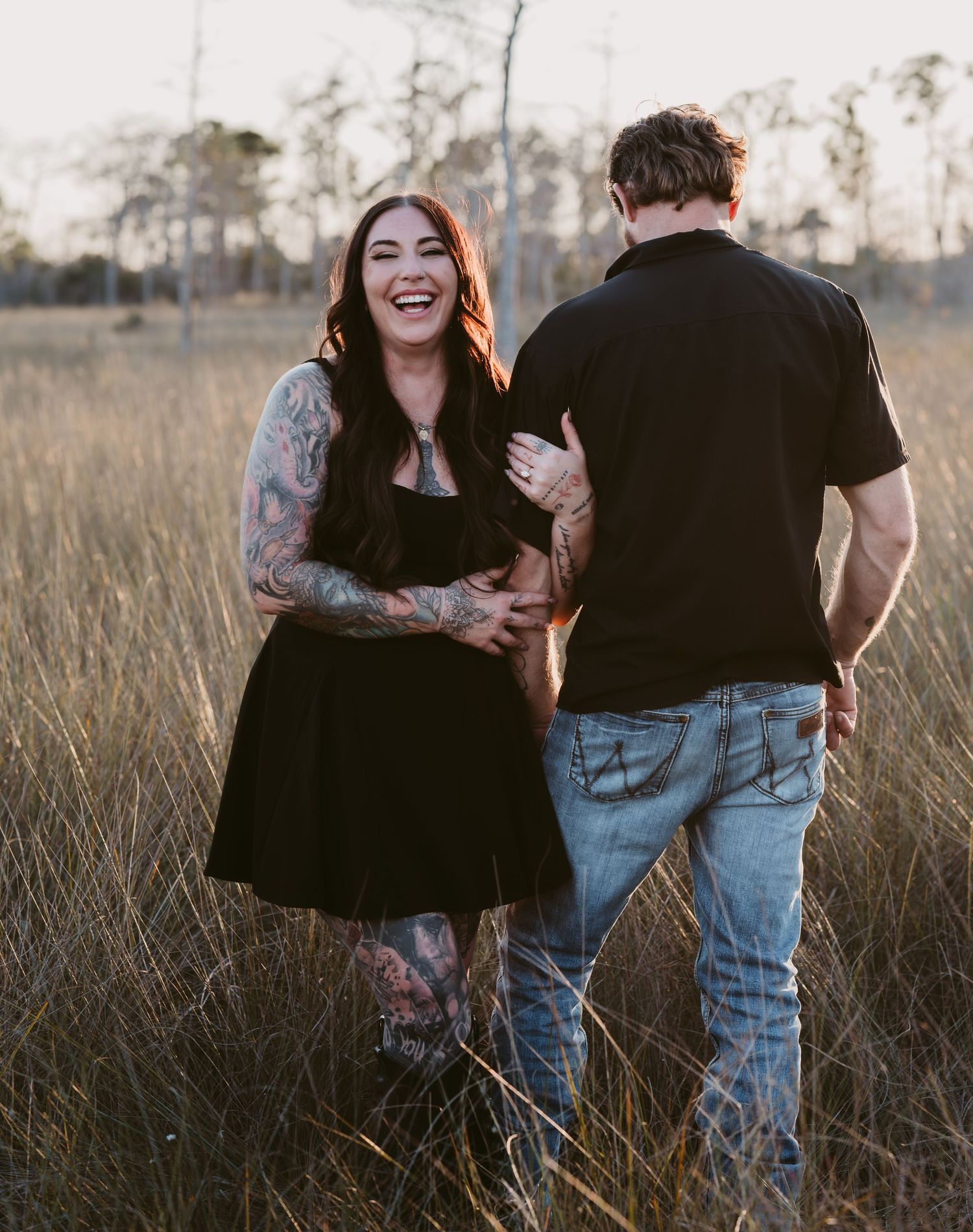 Candid moments between couple during sunset photography session in nature.