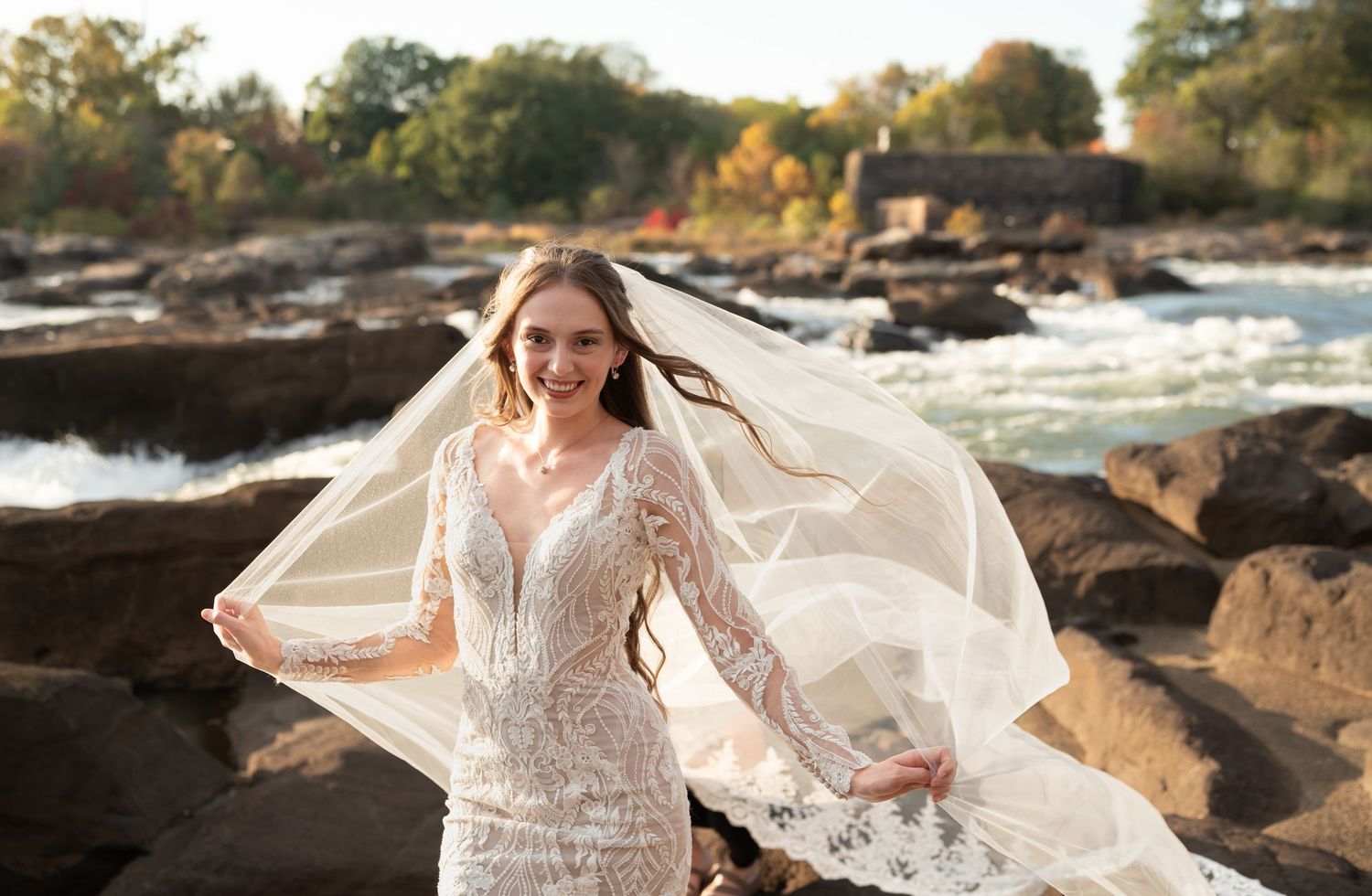 A scenic bridal photo session with flowing white dress and veil along a rocky coastline.