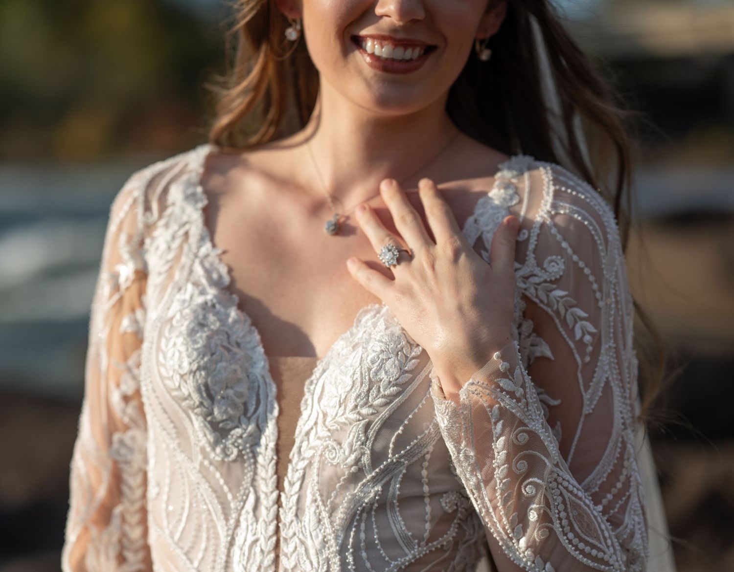 Close-up detail shots of delicate white lace wedding dress with intricate floral patterns and embroidery.