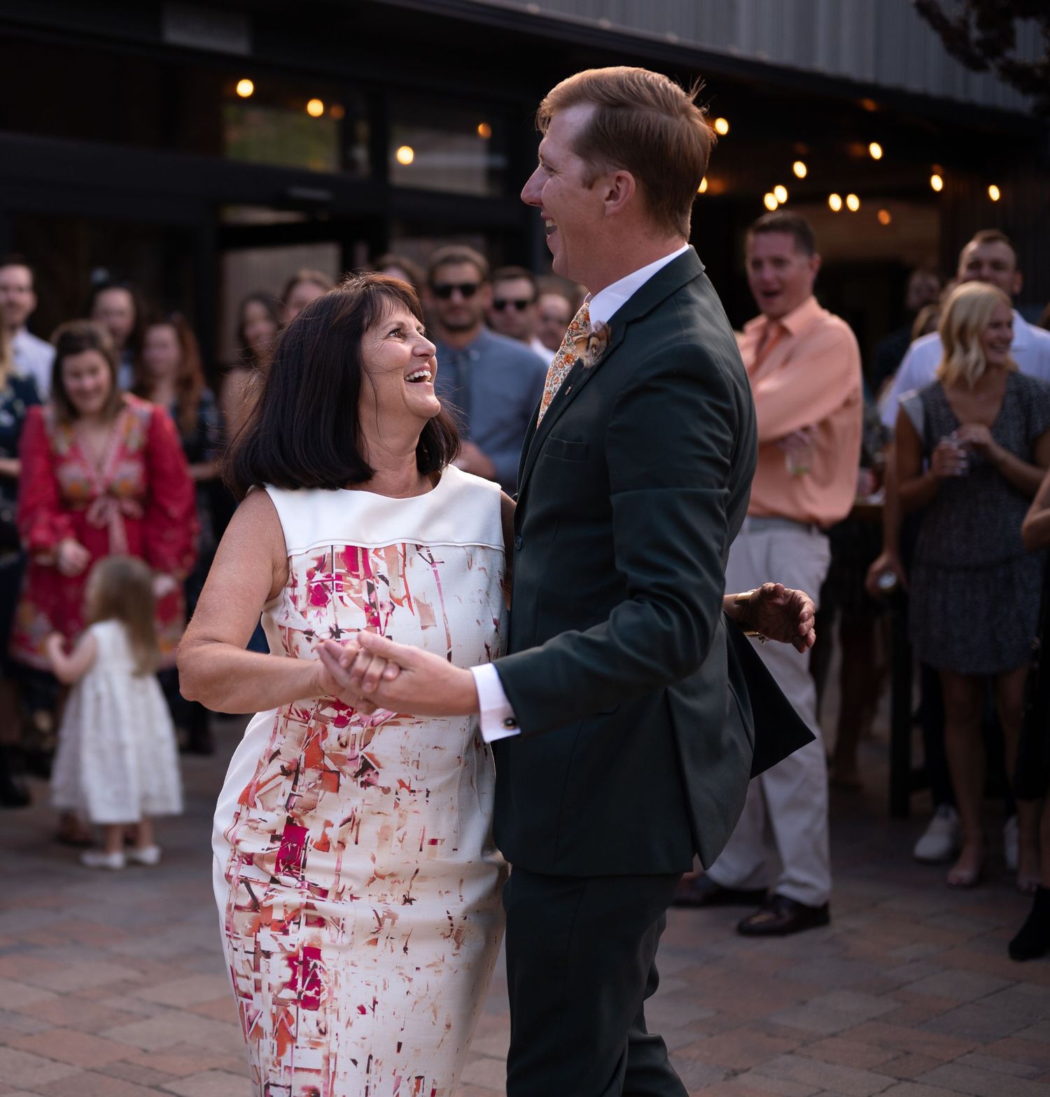 A dancing couple share a joyful moment during their wedding celebration.