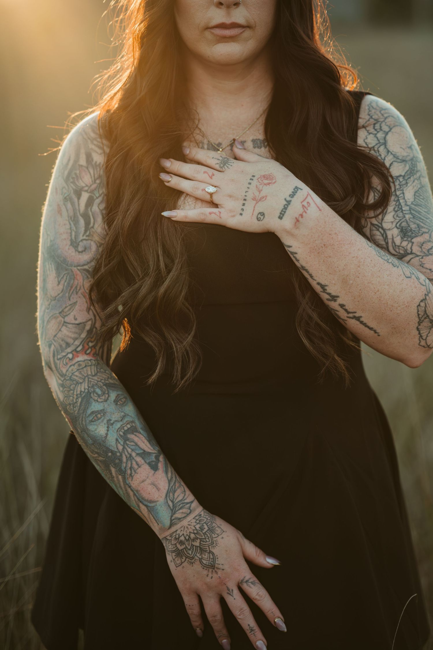 Close-up of intricate floral and nature-themed tattoo sleeve artwork on an arm against a black top.