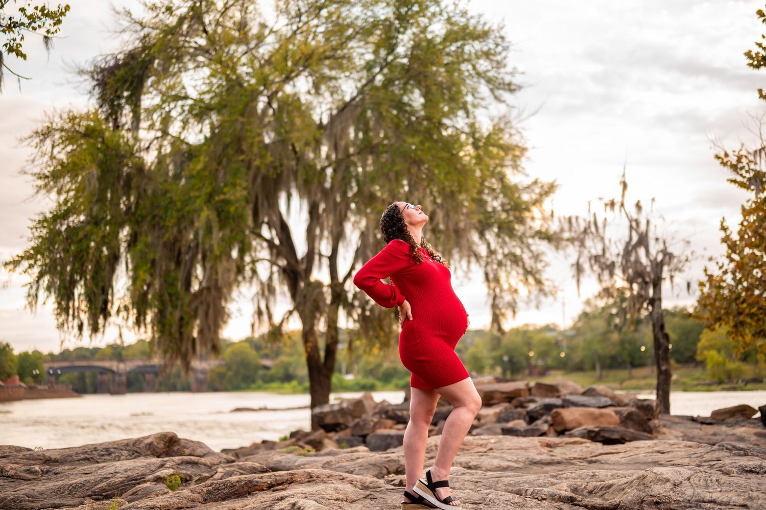 Autumn trees frame a scenic waterfront photoshoot location with rocky outcroppings.