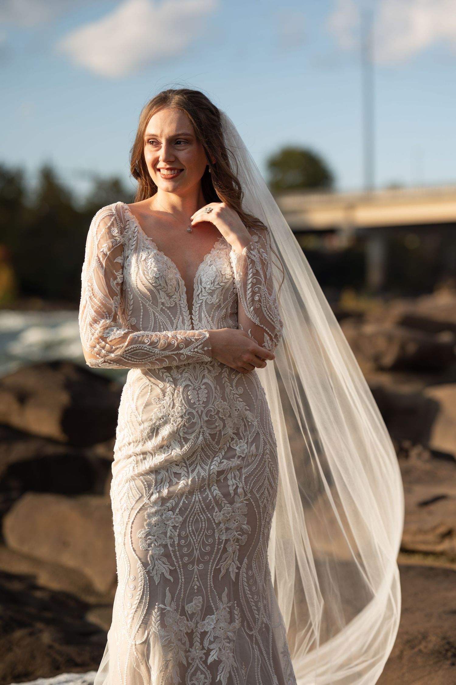 Ethereal bridal photography showing delicate lace details and flowing veil against autumn scenery.