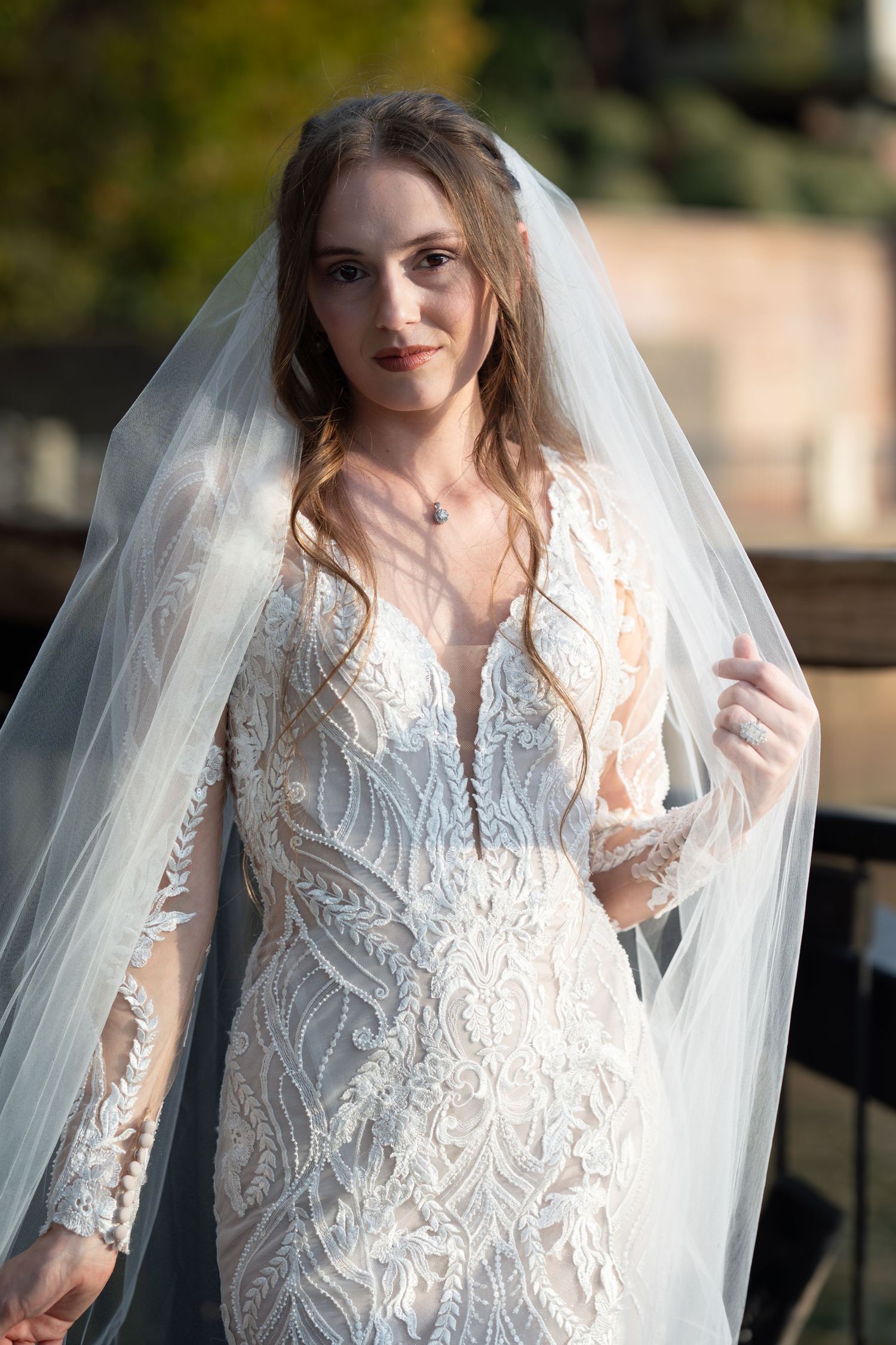 Close-up bridal portrait showcasing detailed lace bodice and classic tulle veil.