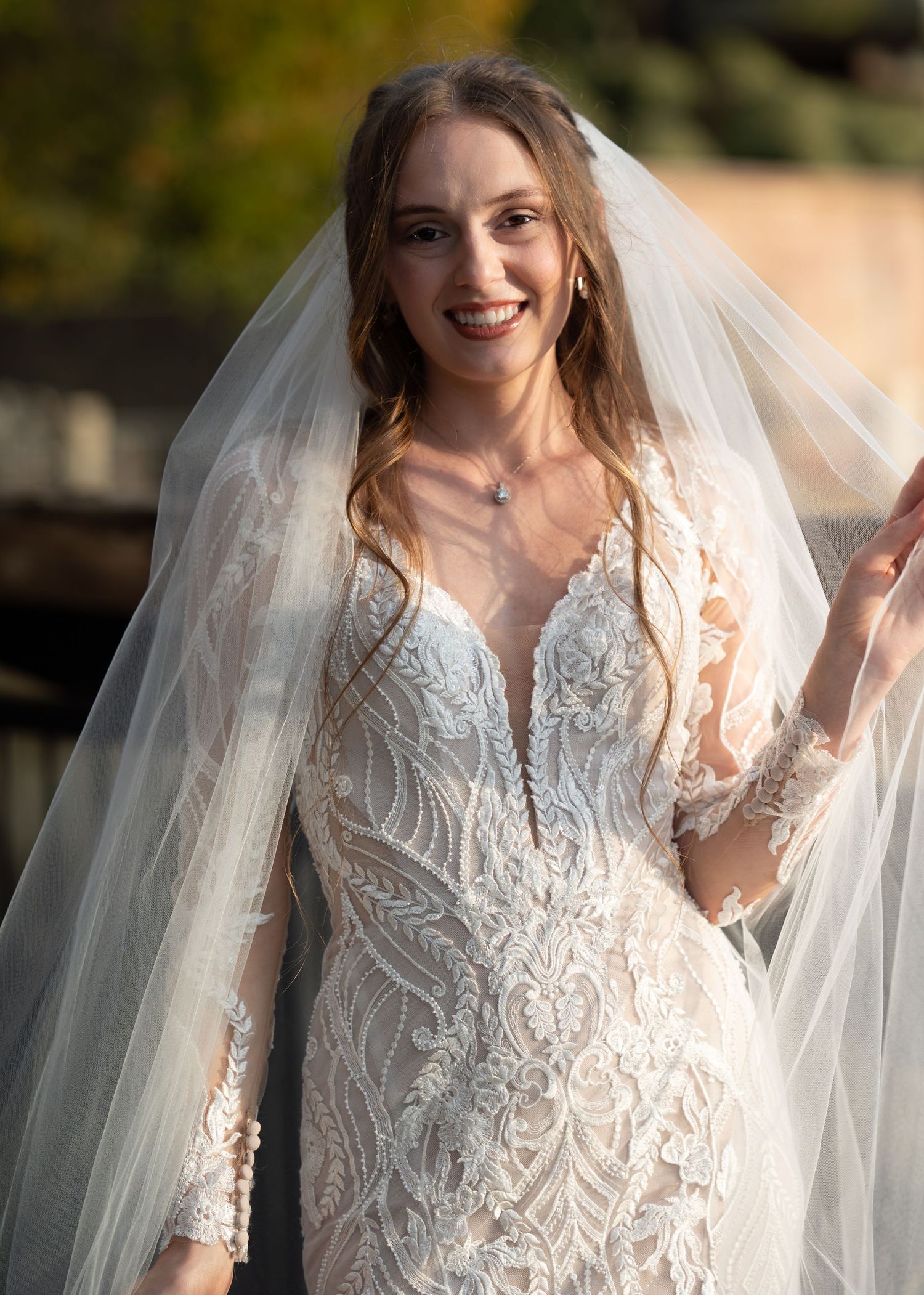 A close-up series of a stunning lace wedding gown with delicate embroidery details and flowing veil.
