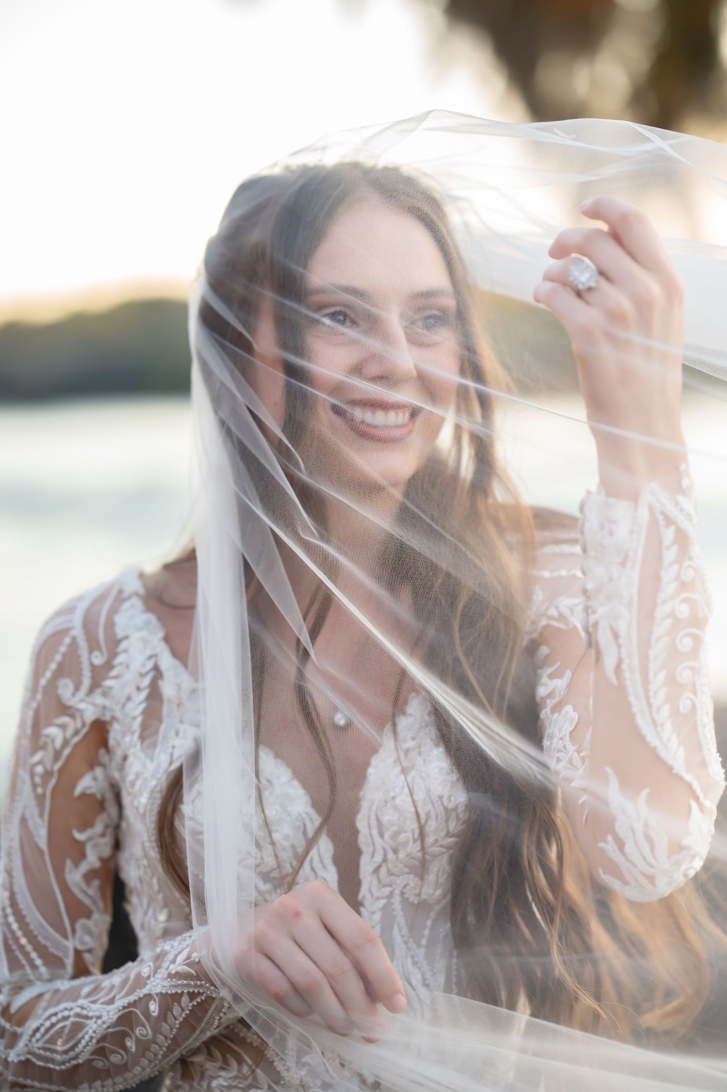 Dreamy bridal portraits with soft focus and flowing veil in natural light.