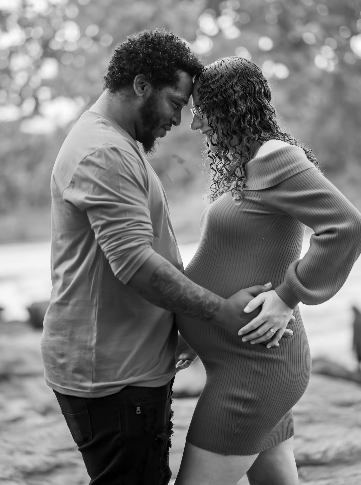 Intimate black and white photography of a couple embracing on a peaceful afternoon.